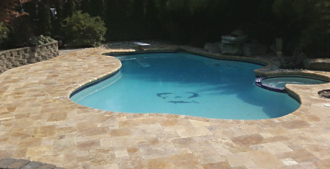 Travertine pool patio installed by Green Nature Landscape Design in Morris County, NJ.