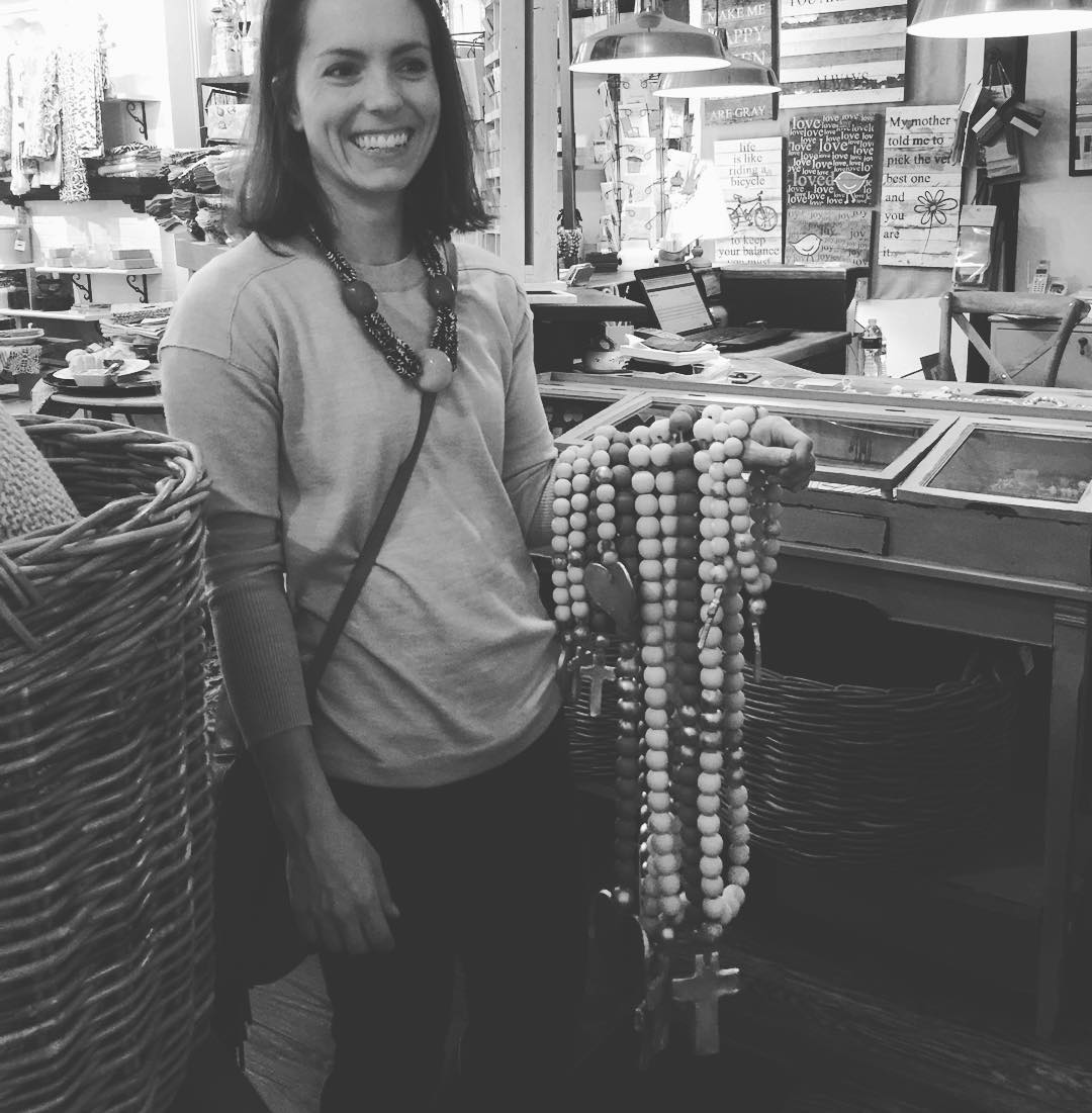 Our favorite picture of Mackenzie holding many strands of Blessing Beads 