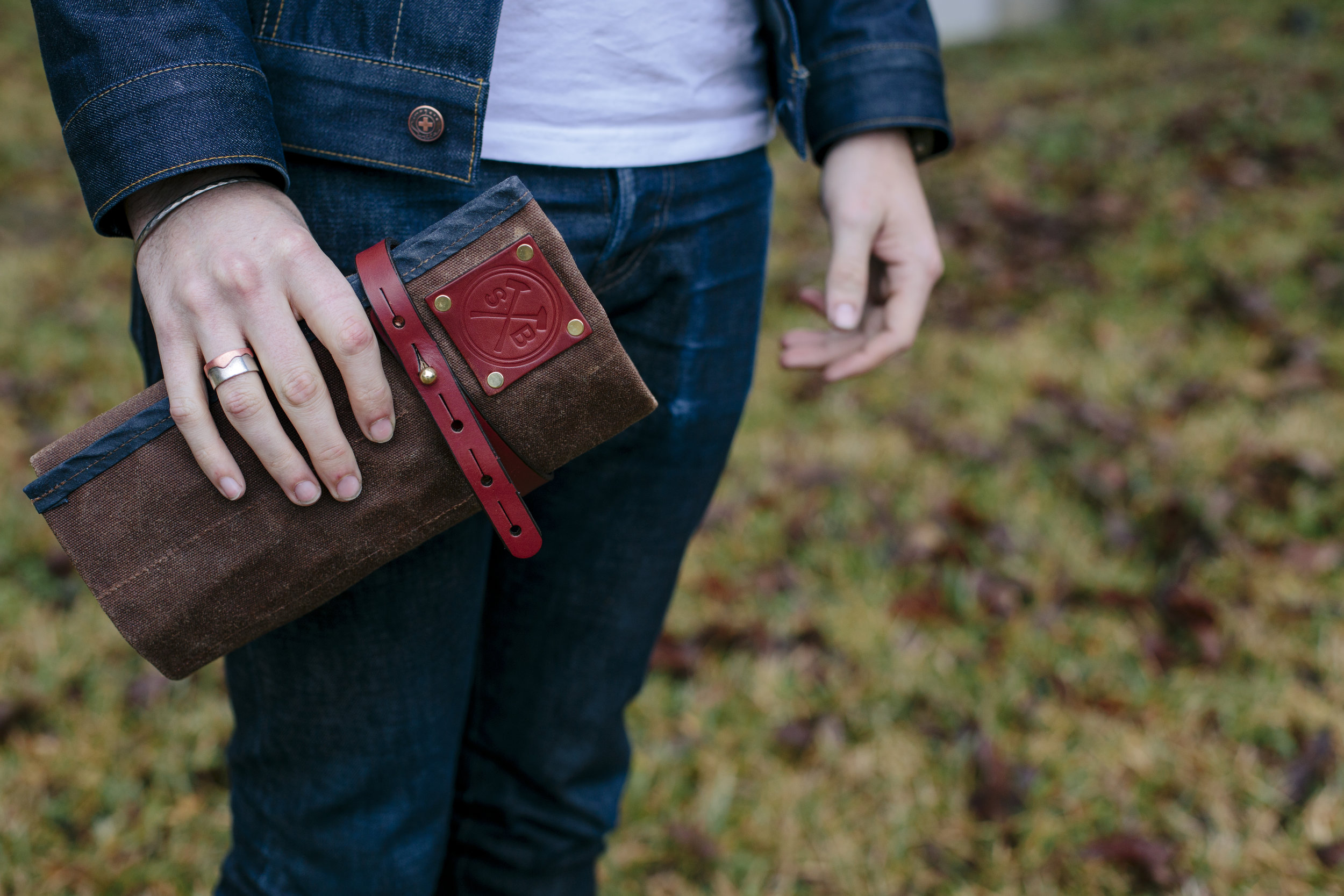 orville tool roll in hand sturdy brothers waxed canvas.jpg