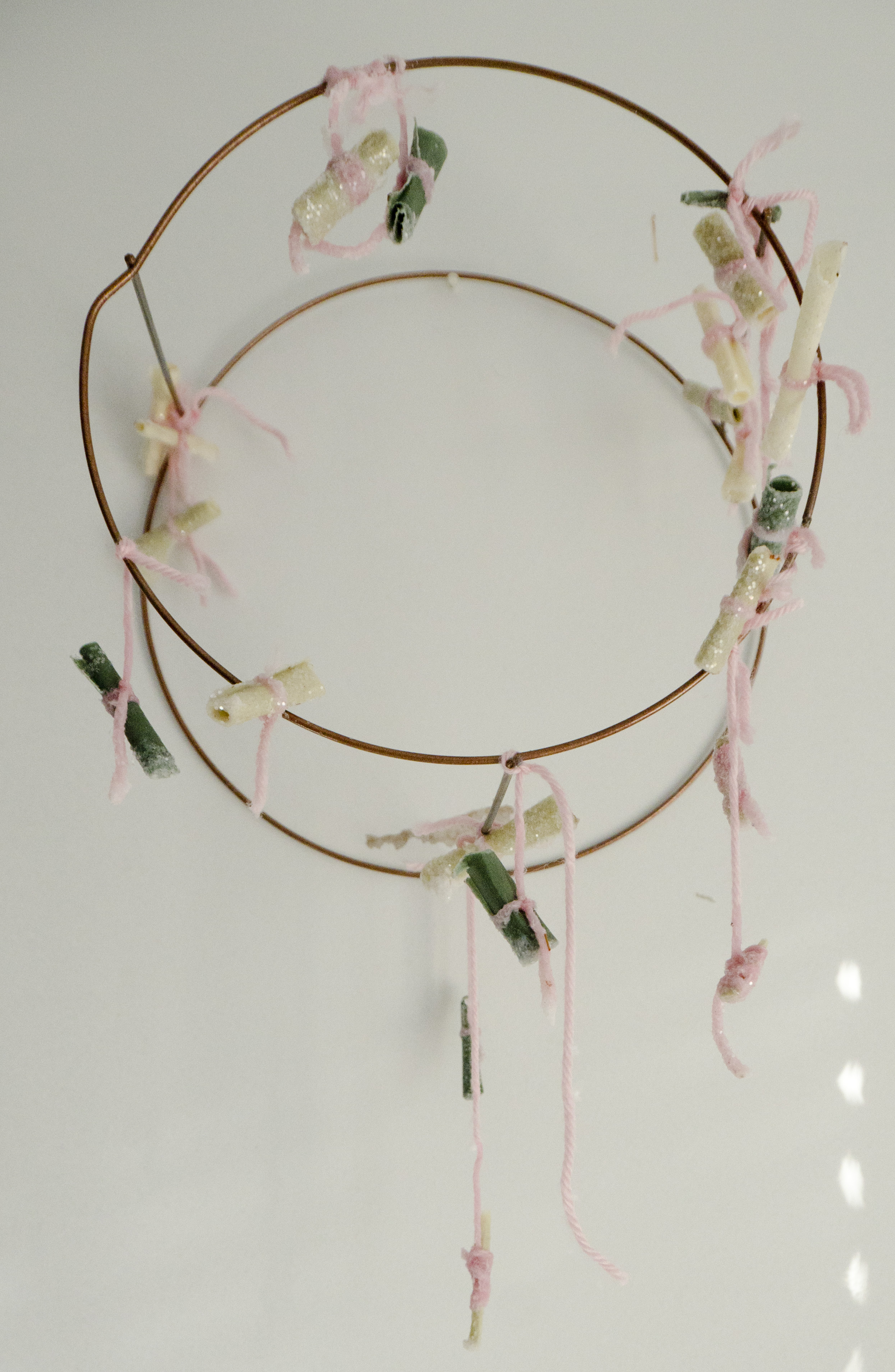   For Protection and Affection   2018  Wax, herbs, glitter, yarn, pencil, and paper, on wire armature  the artifact from the performance piece, containing the charms made during the event 