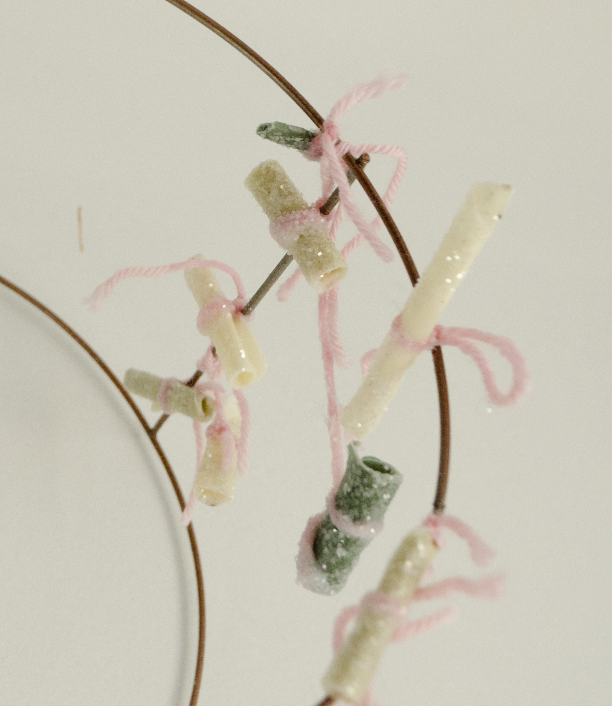   For Protection and Affection  (Detail)  2018  Wax, herbs, glitter, yarn, pencil, and paper, on wire armature  the artifact from the performance piece, containing the charms made during the event 