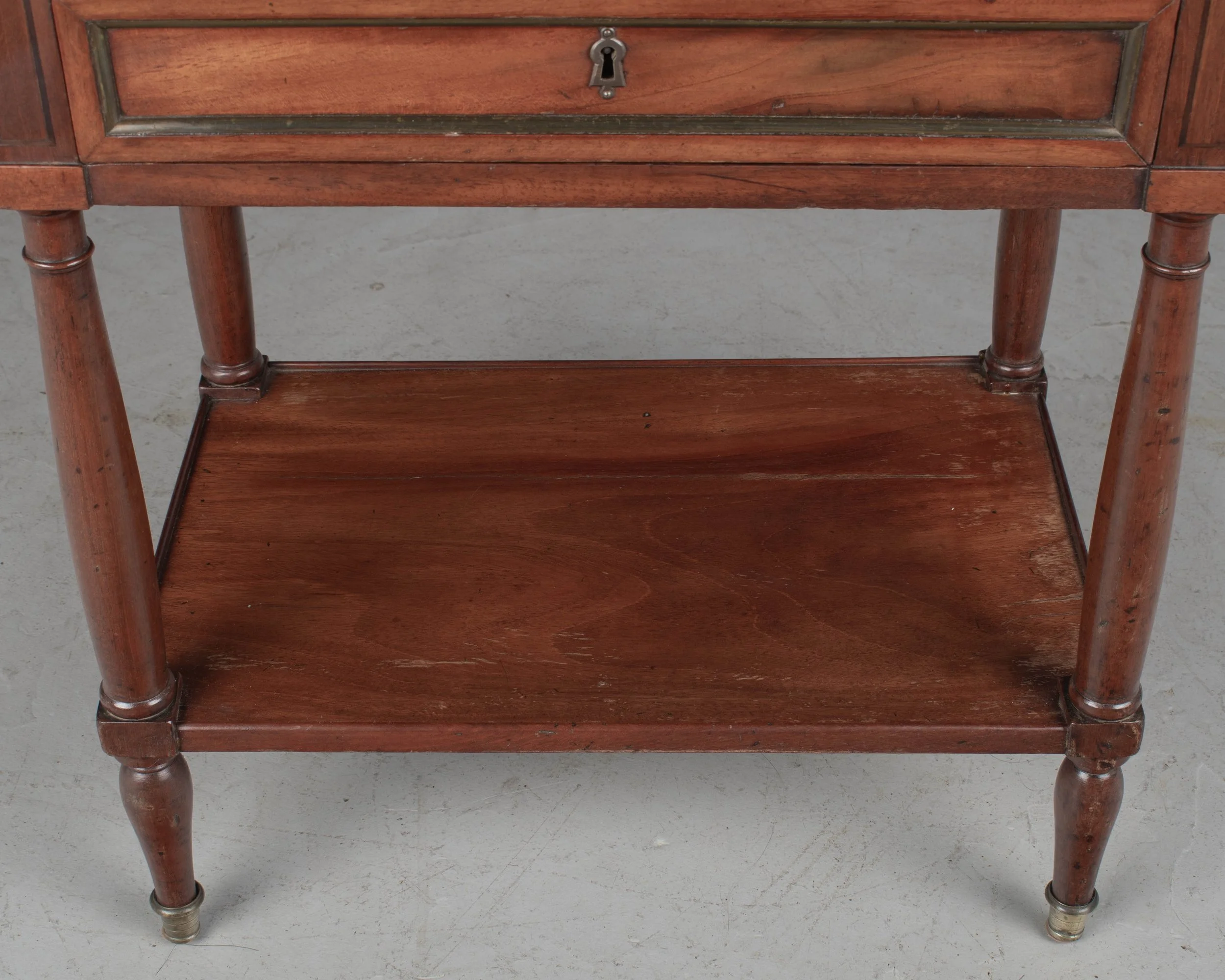 A 19th century French Louis XVI style marble top nightstand, or side table, made of veneers of mahogany with solid oak as a secondary wood