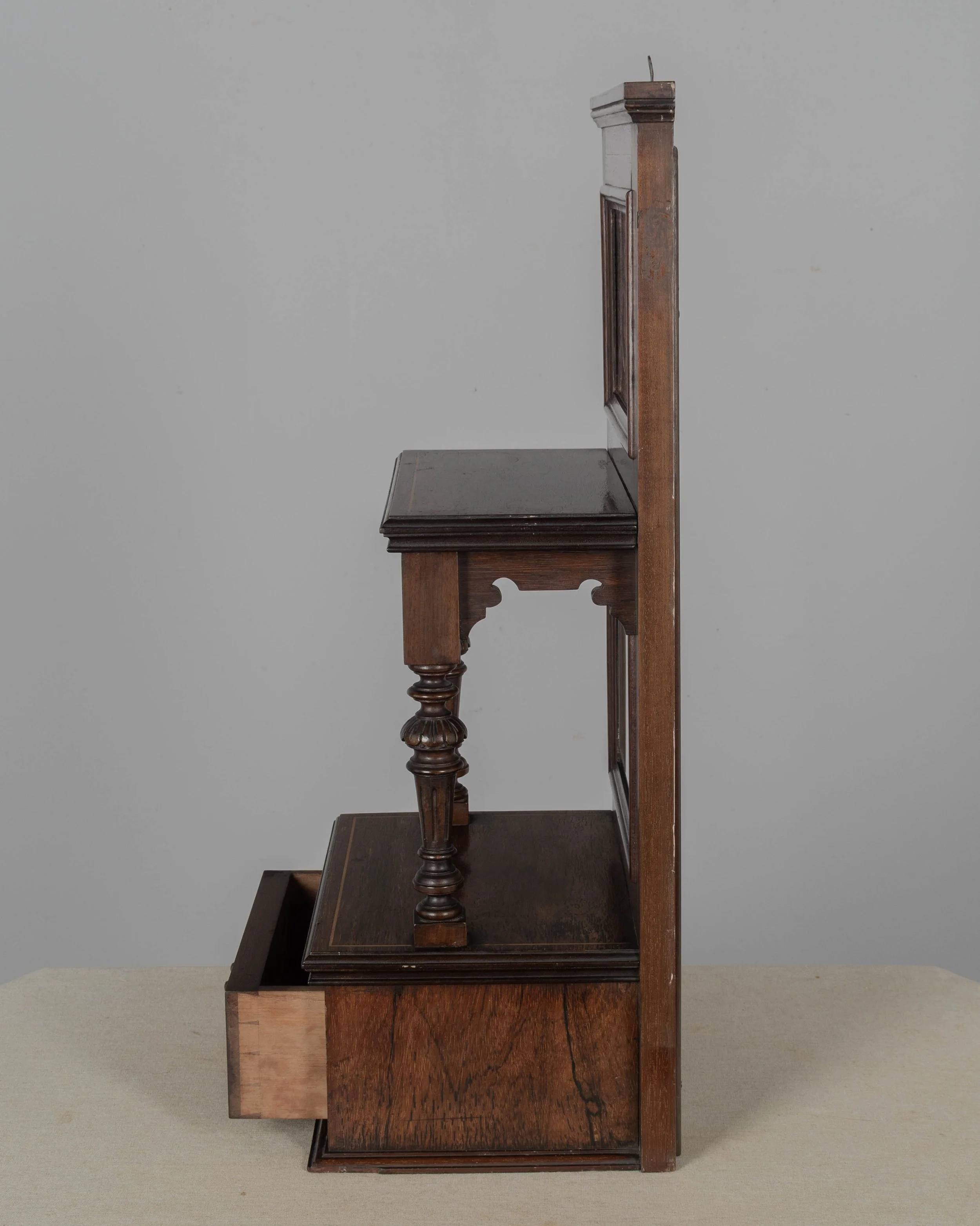A 19th century English Edwardian vitrine constructed using rich, finely grained rosewood with contrasting satinwood marquetry.