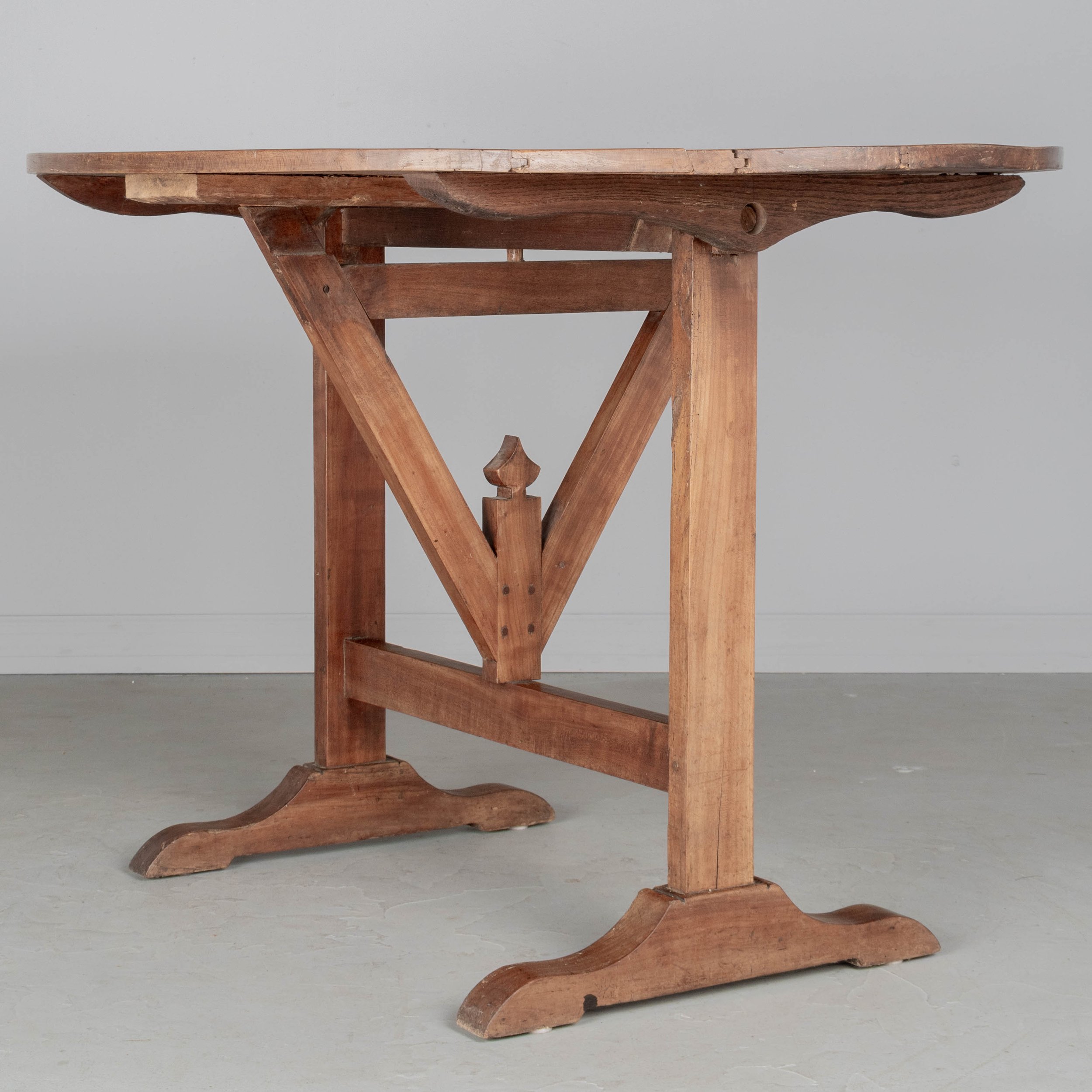 French oval wine tasting, or tilt-top table made of solid cherry.