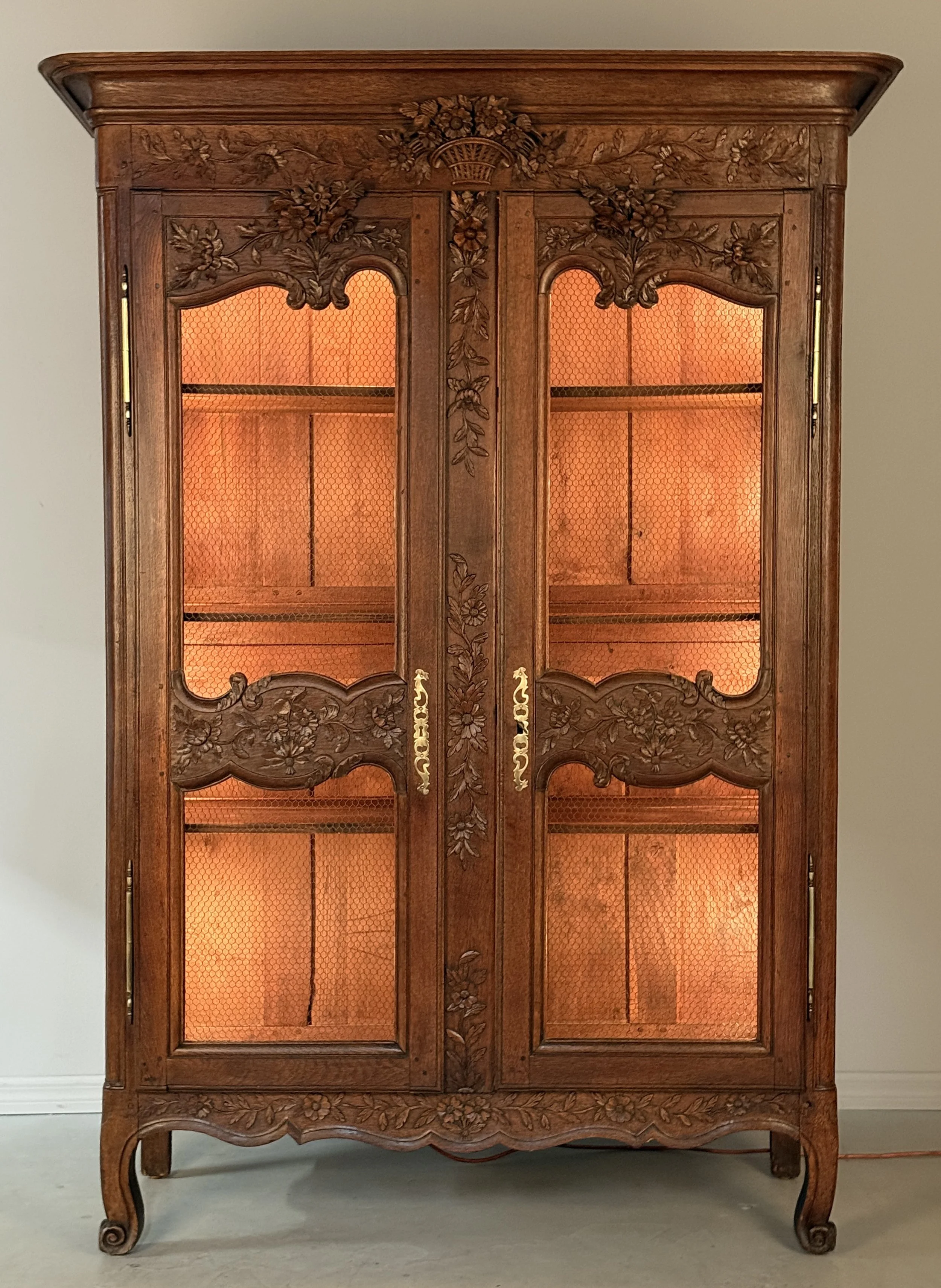 A 19th century Louis XV style Country French armoire, or display cabinet from Normandy.