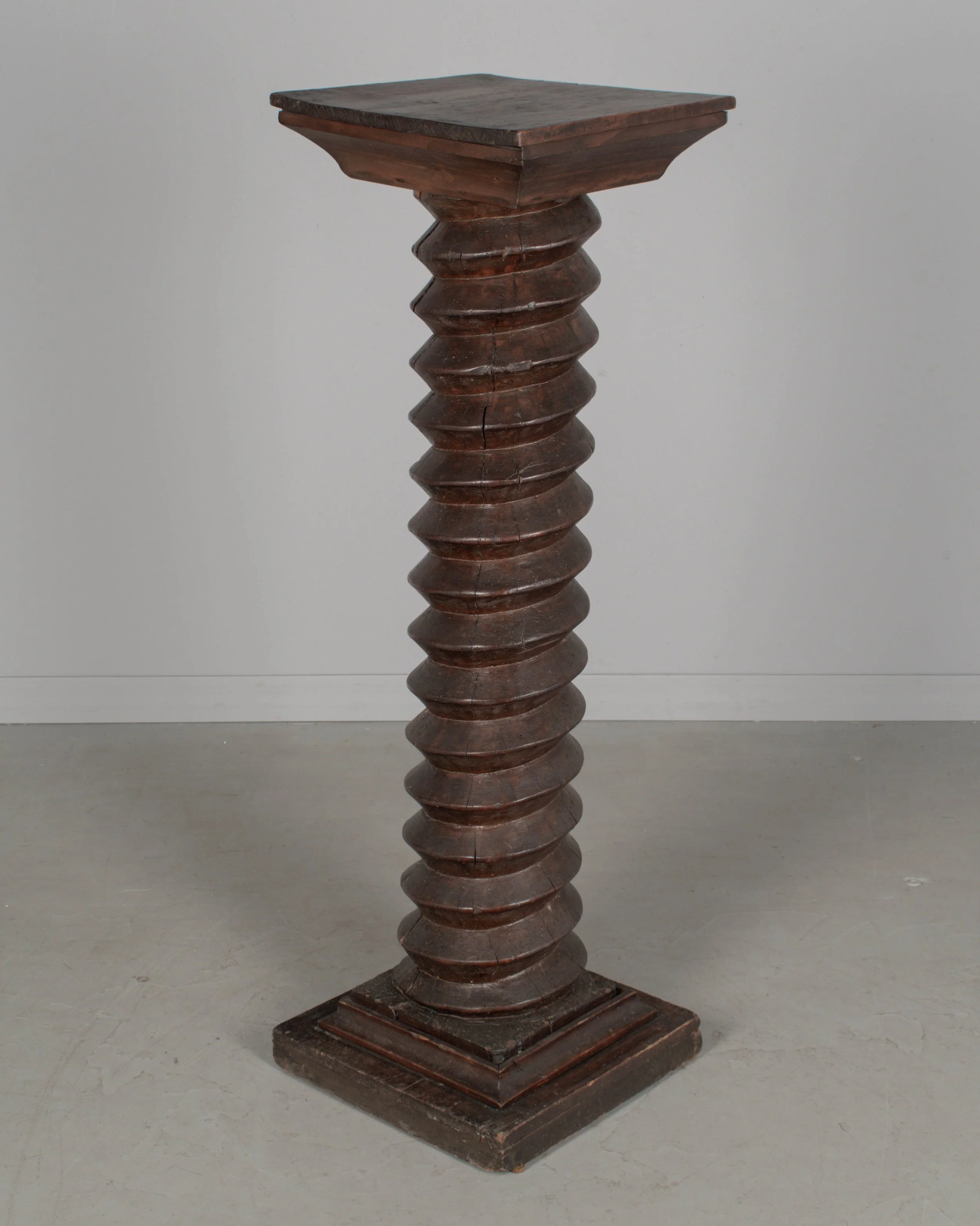 A late 18th century French wooden wine press screw, repurposed as a pedestal or plant stand