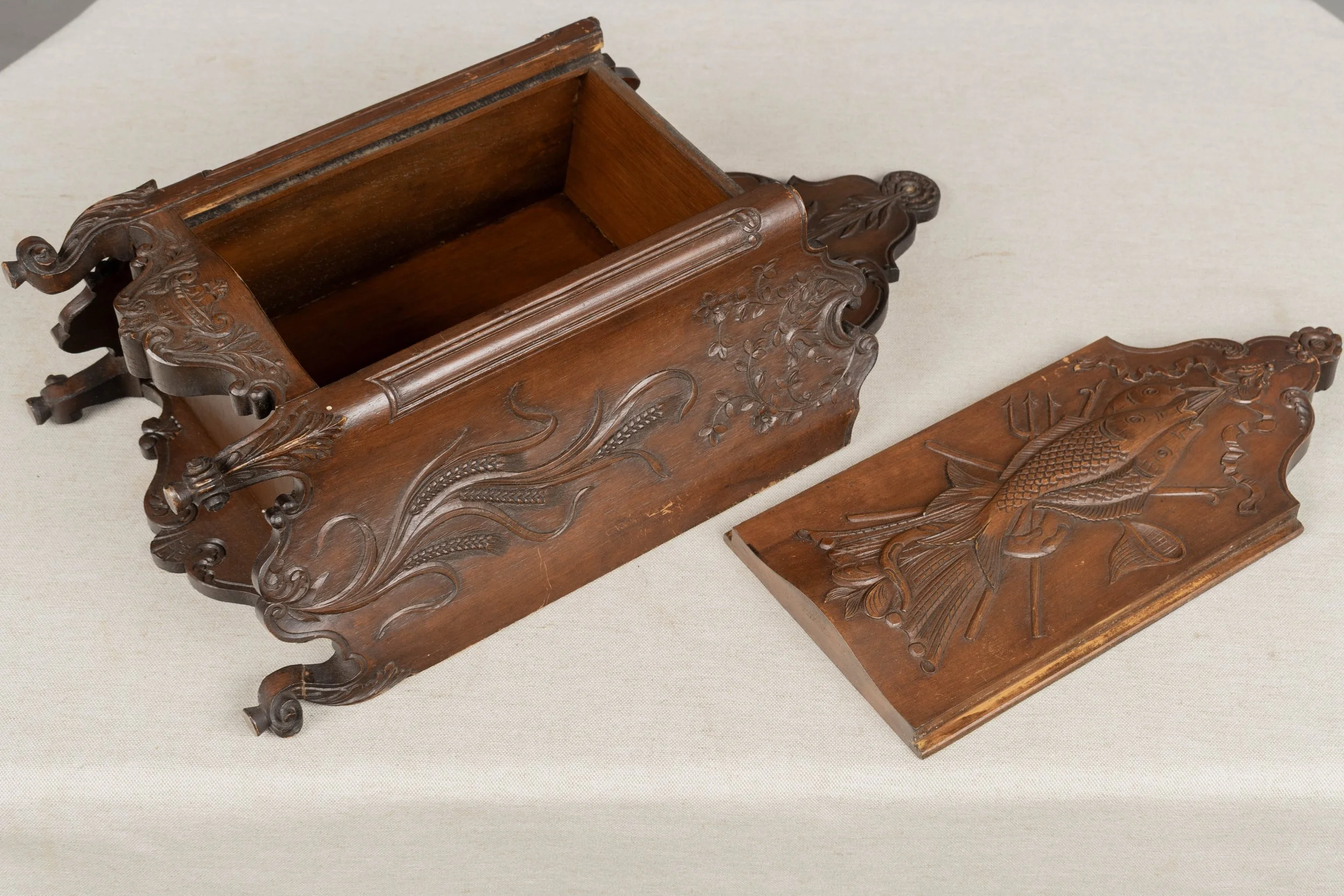 19th century French fariniere made of walnut with nicely detailed hand-carved decorative motifs:
