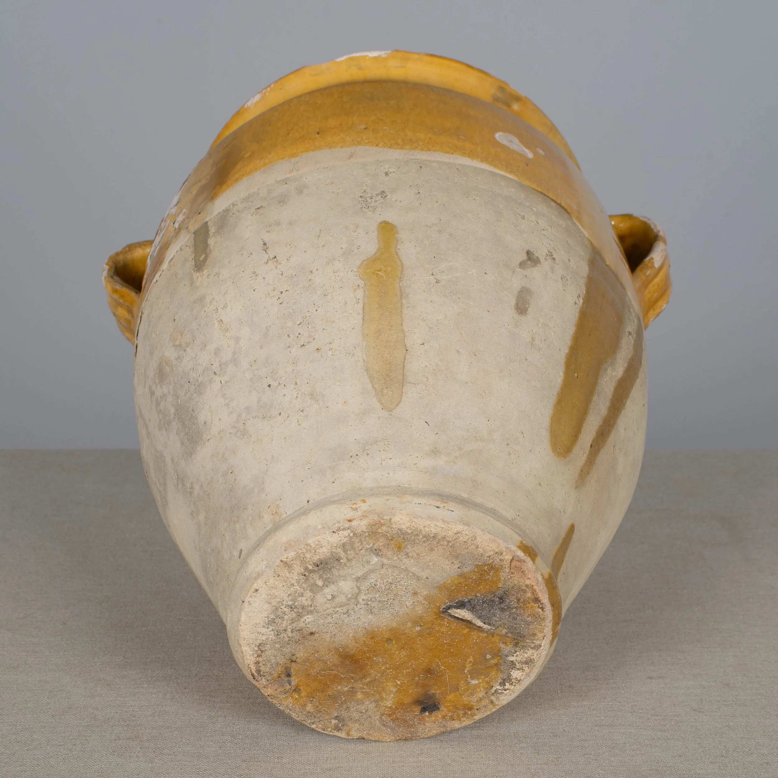 An earthenware confit pot from the Southwest of France with traditional yellow ochre drip glaze.