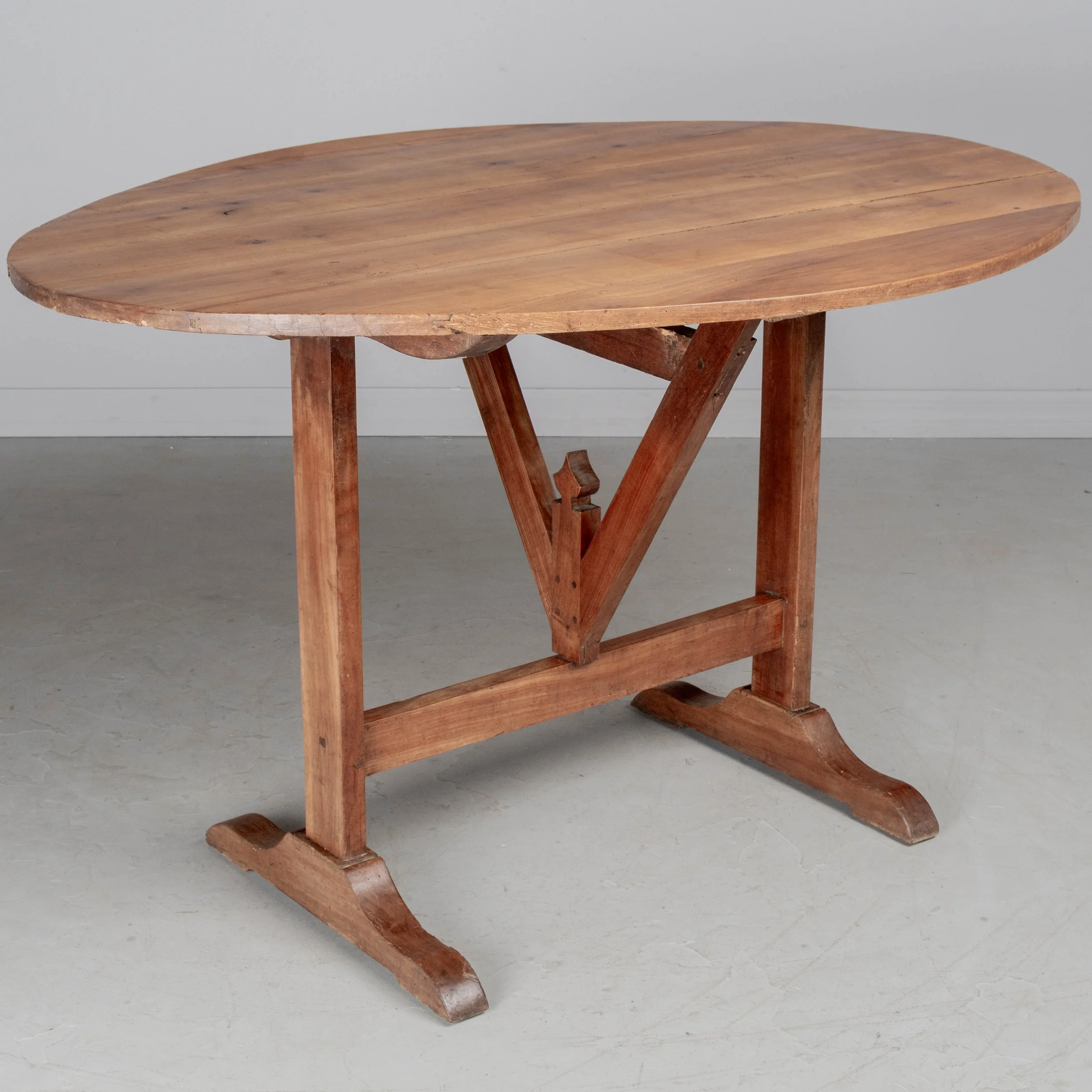 French oval wine tasting, or tilt-top table made of solid cherry.