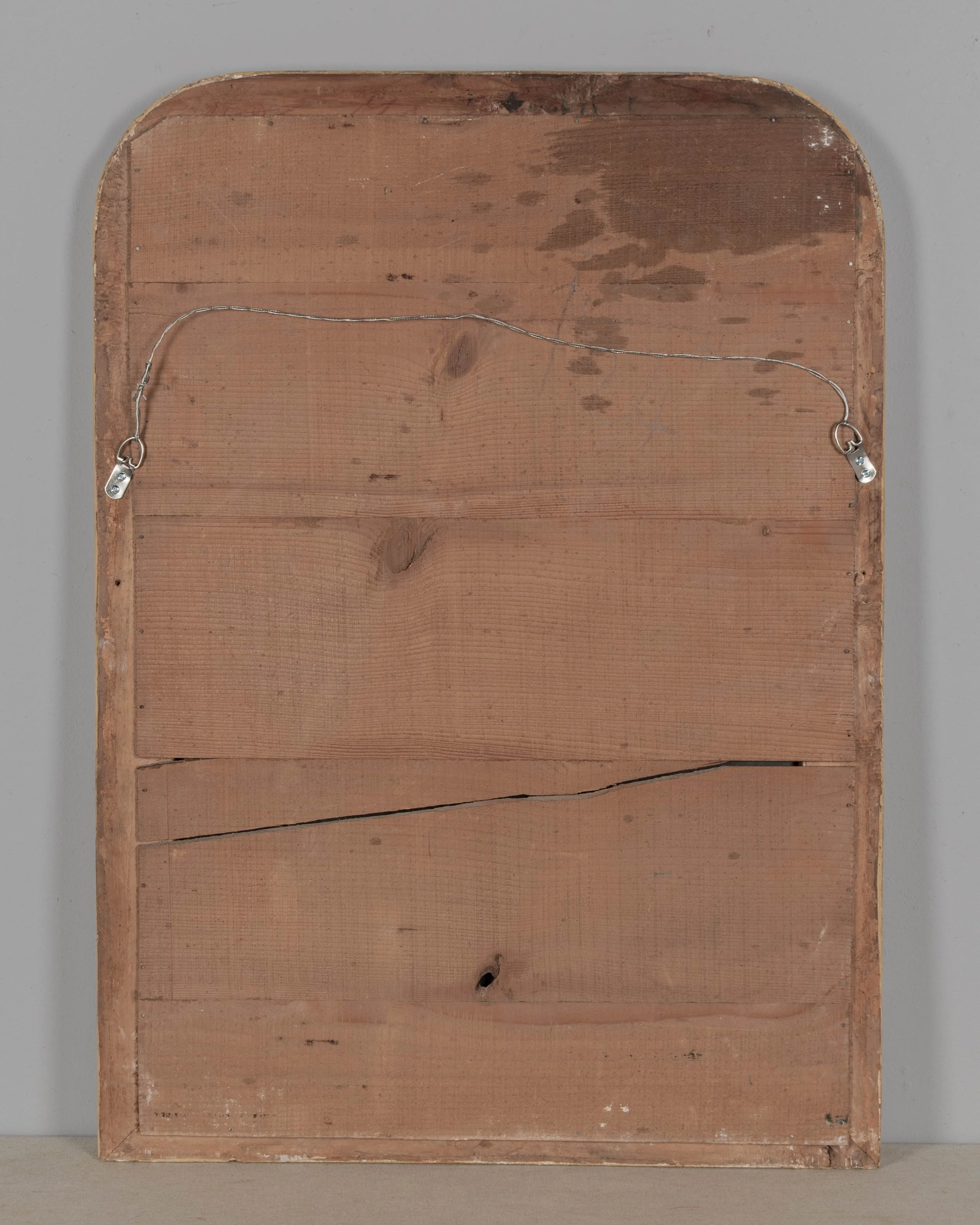 A French Louis Philippe style gilded mirror with curved top corners and incised floral decoration.