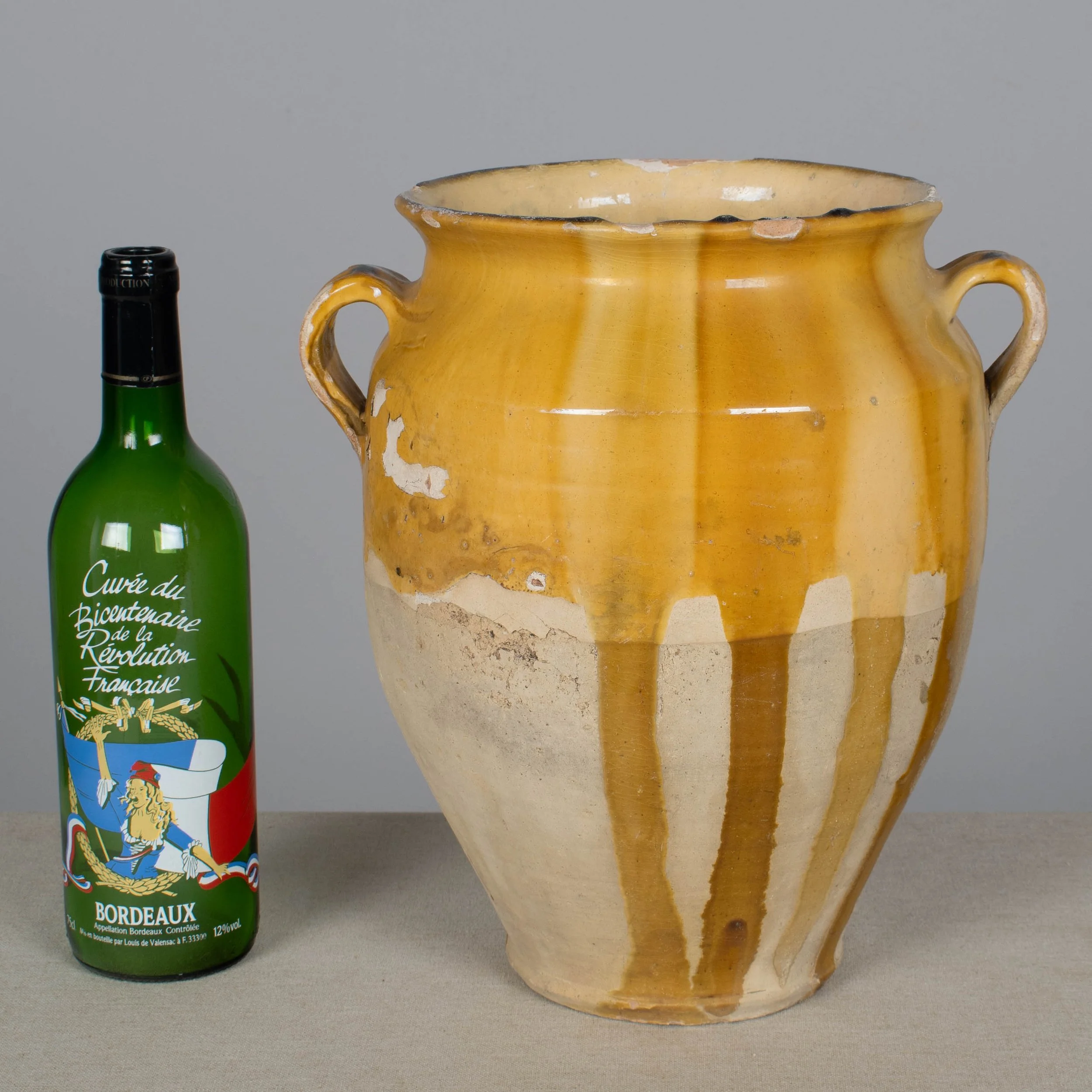 An earthenware confit pot from the Southwest of France with traditional yellow ochre drip glaze.