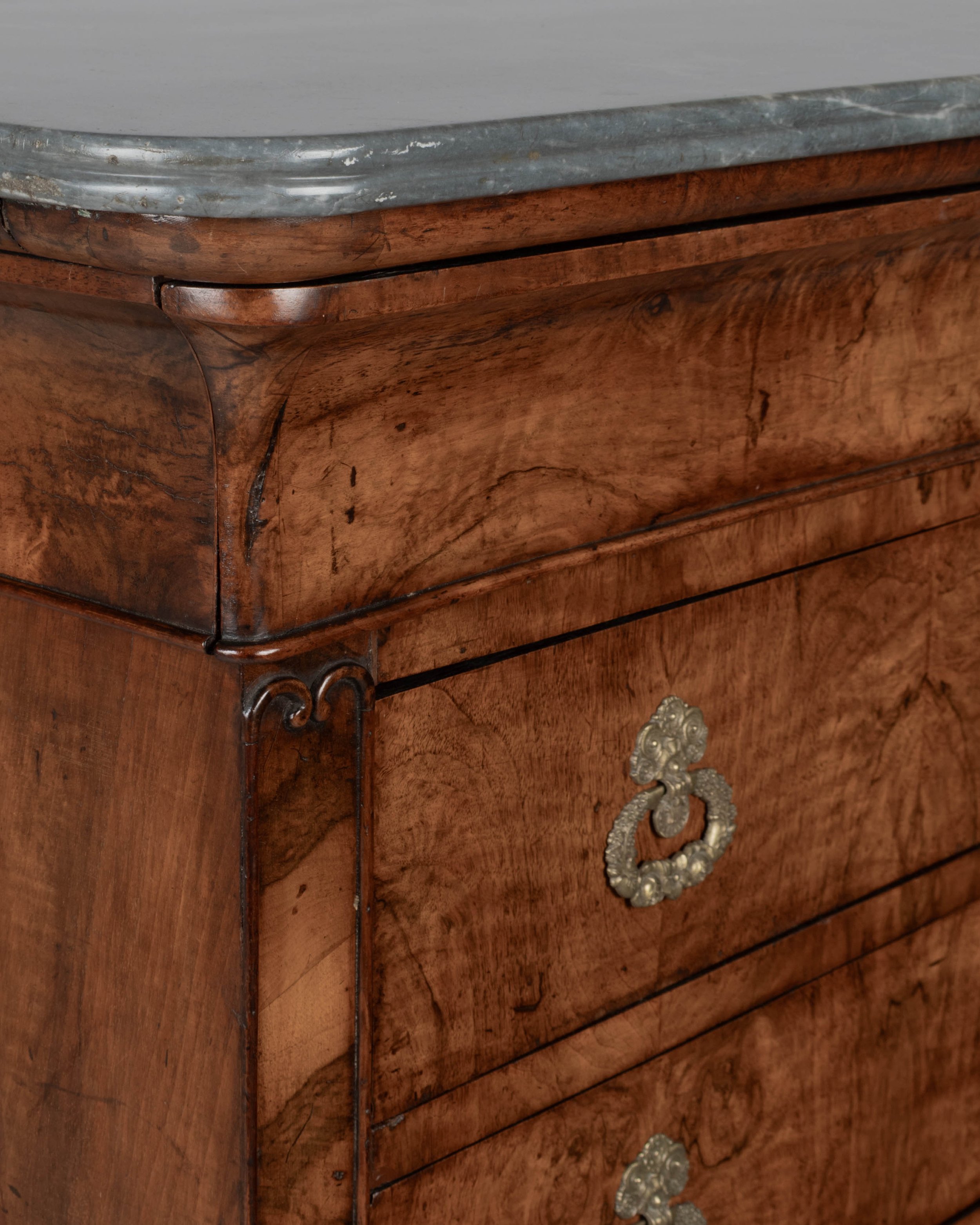 An early 19th century French Louis Philippe marble top walnut commode, or chest of drawers.