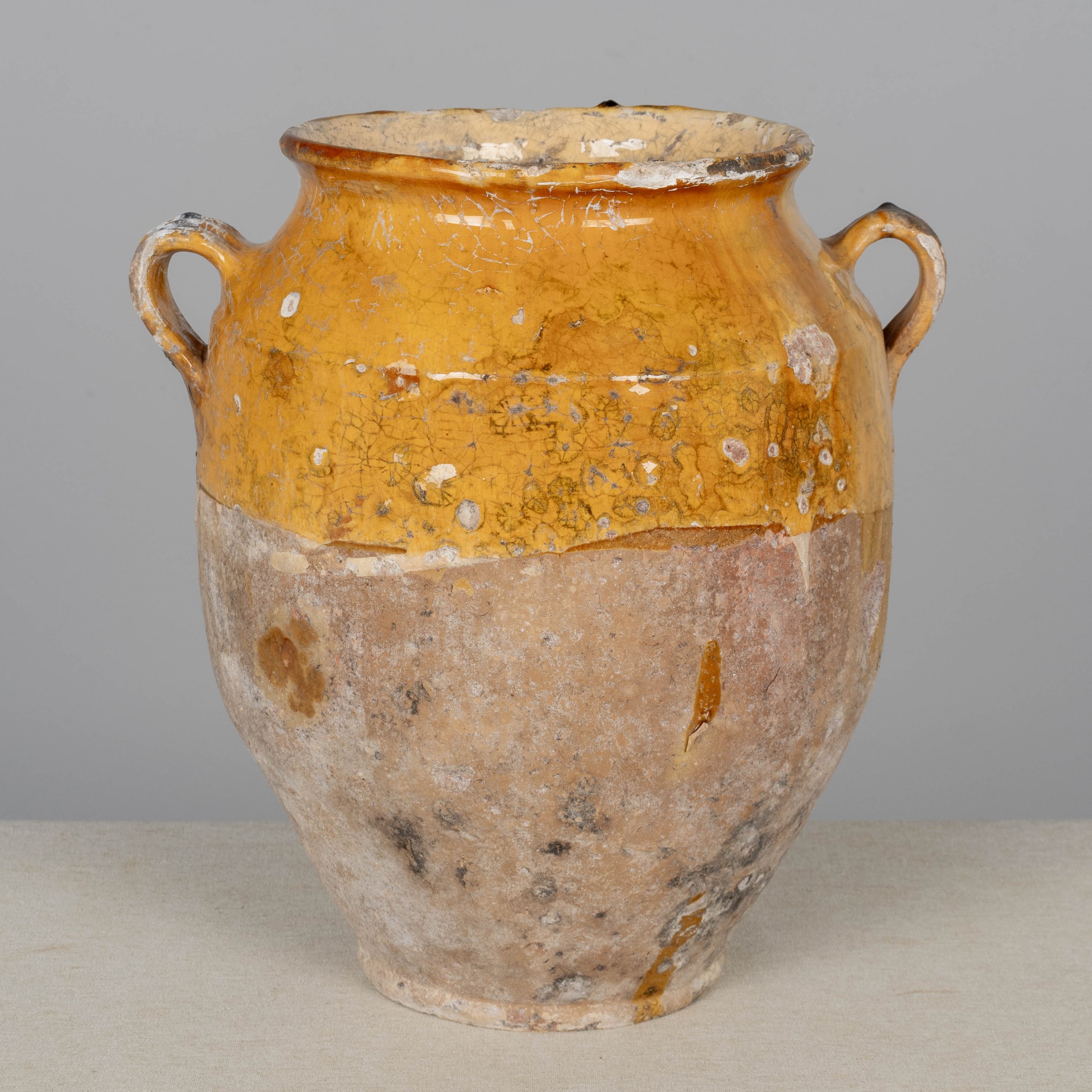 A 19th century French earthenware pot à confit with traditional yellow glaze