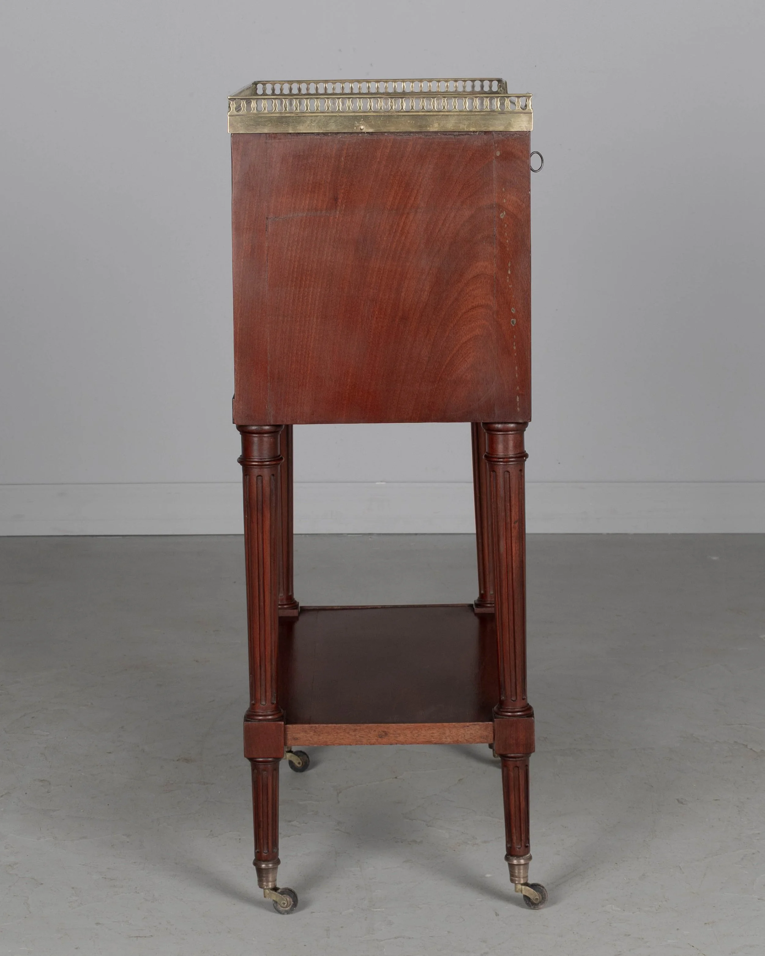 A 19th century French Louis XVI style marble top nightstand, or side table, made of veneers of mahogany with solid oak as a secondary wood