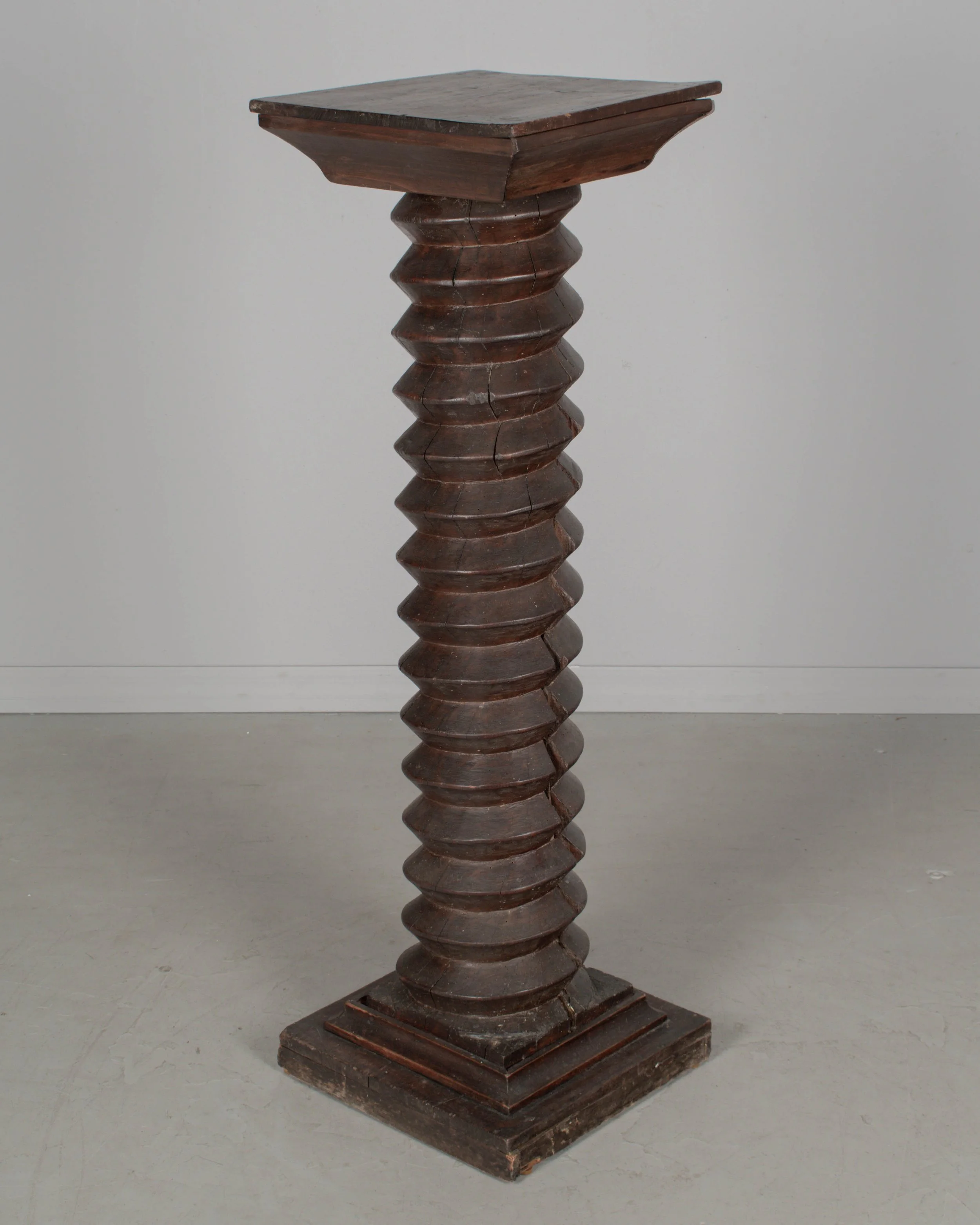A late 18th century French wooden wine press screw, repurposed as a pedestal or plant stand