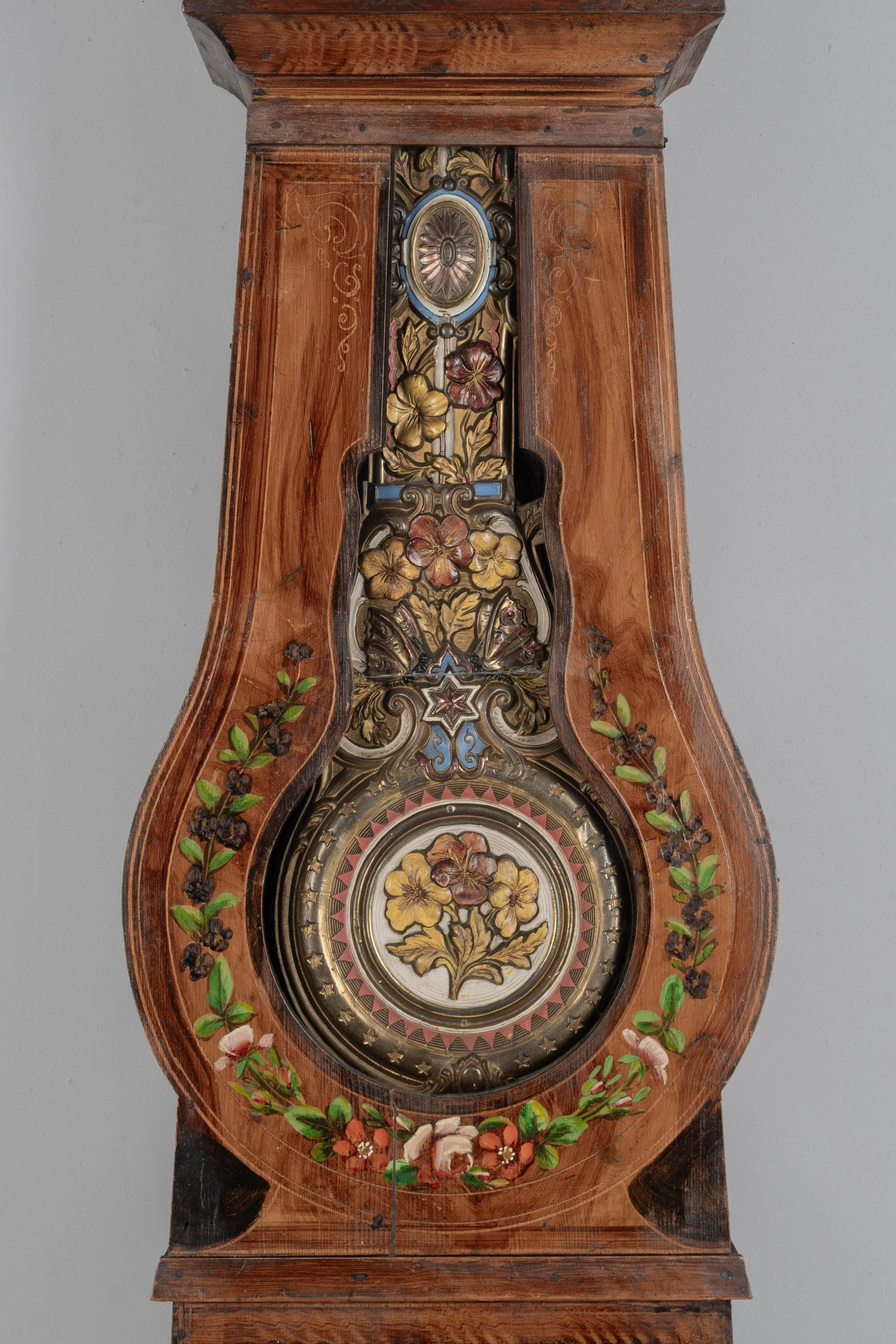 19th century Country French comtoise, or grandfather clock, with polychrome painted pine case and embossed brass pendulum.