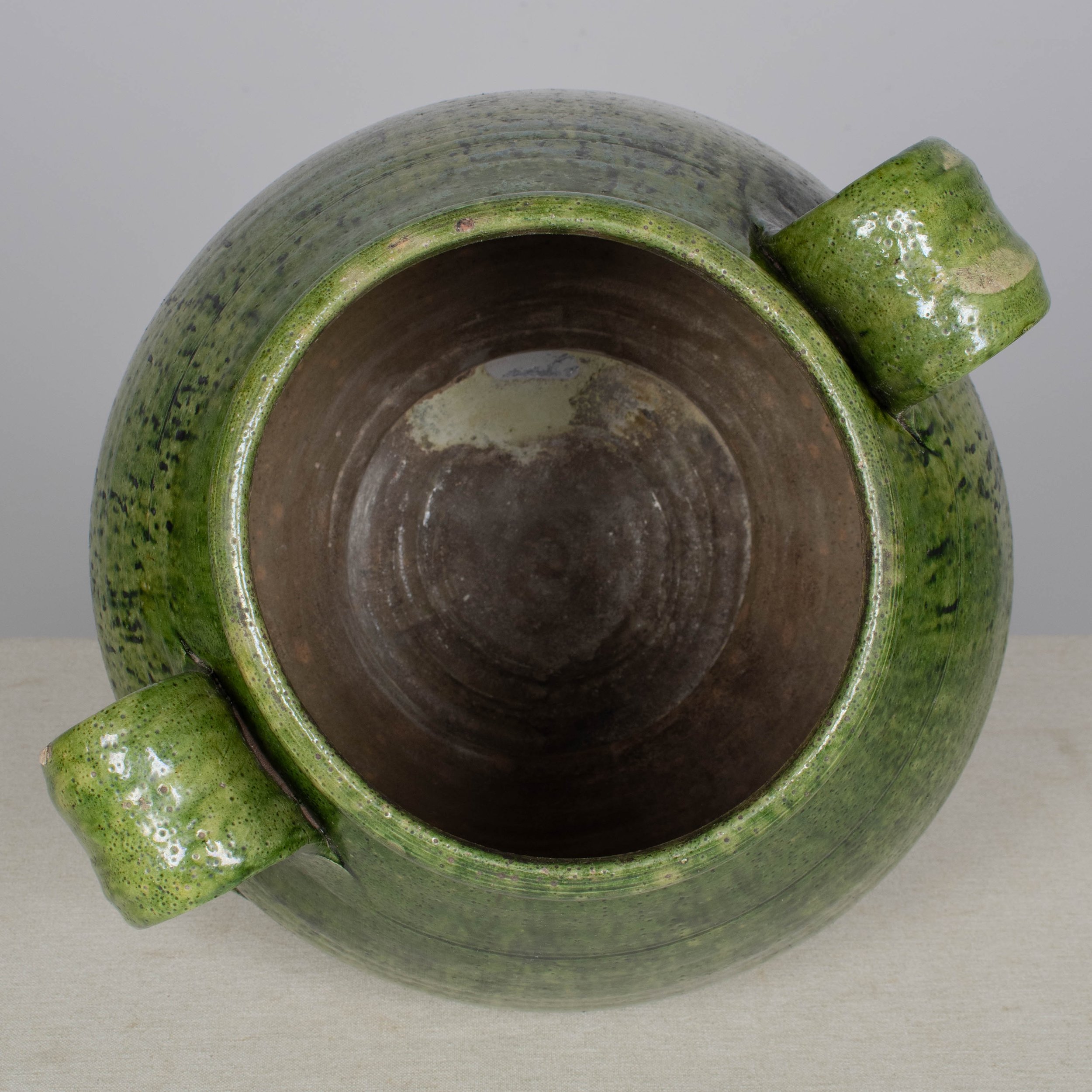 A large green glazed earthenware lidded jar made in Portugal