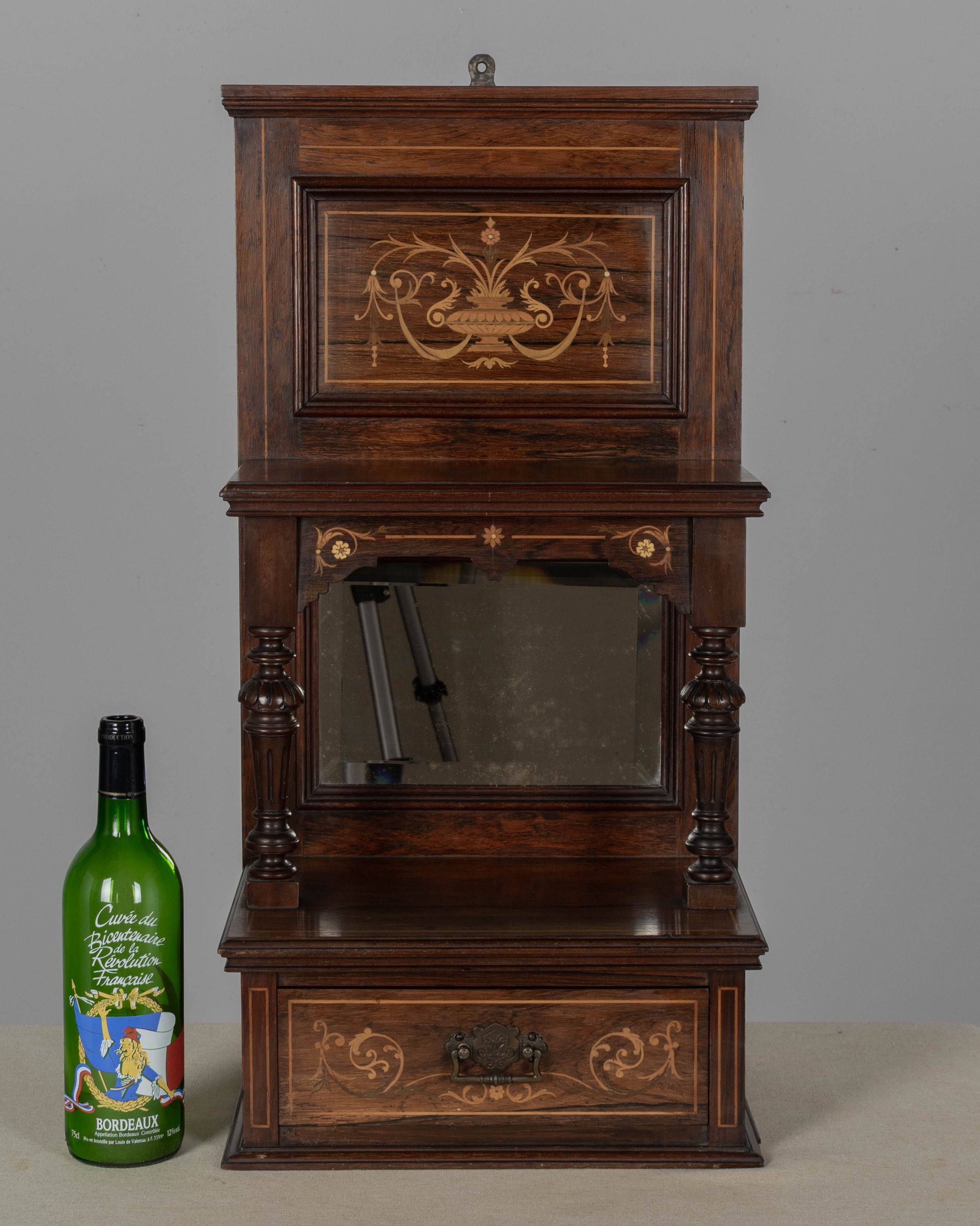 A 19th century English Edwardian vitrine constructed using rich, finely grained rosewood with contrasting satinwood marquetry.