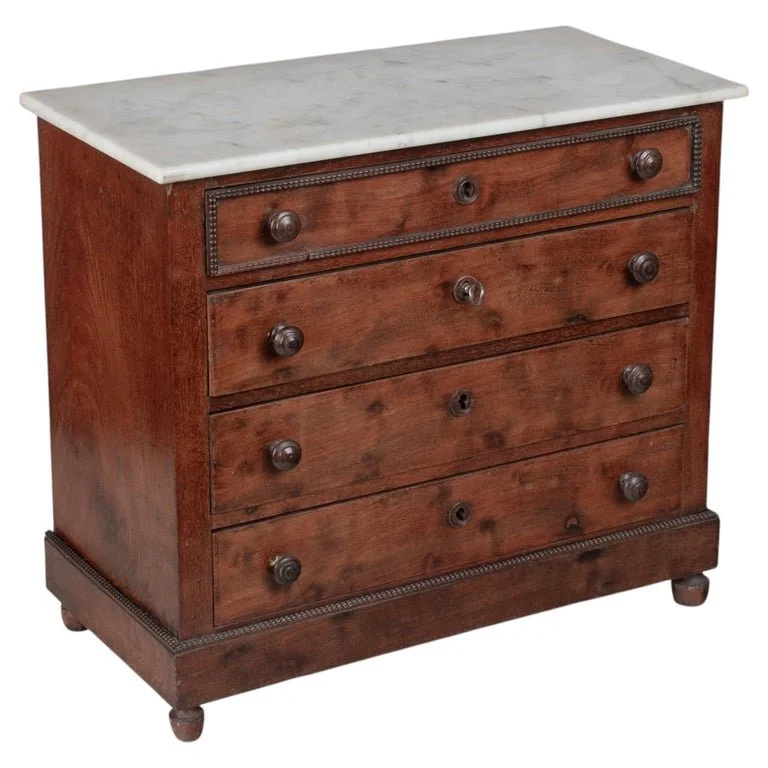A 19th century Louis Philippe miniature sample commode made of mahogany with French polish finish. Four dovetailed drawers with turned knobs and escutcheons