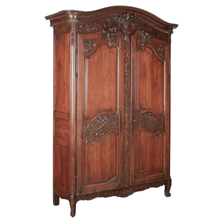 An early 19th century Louis XV country French bridal armoire from Normandy.