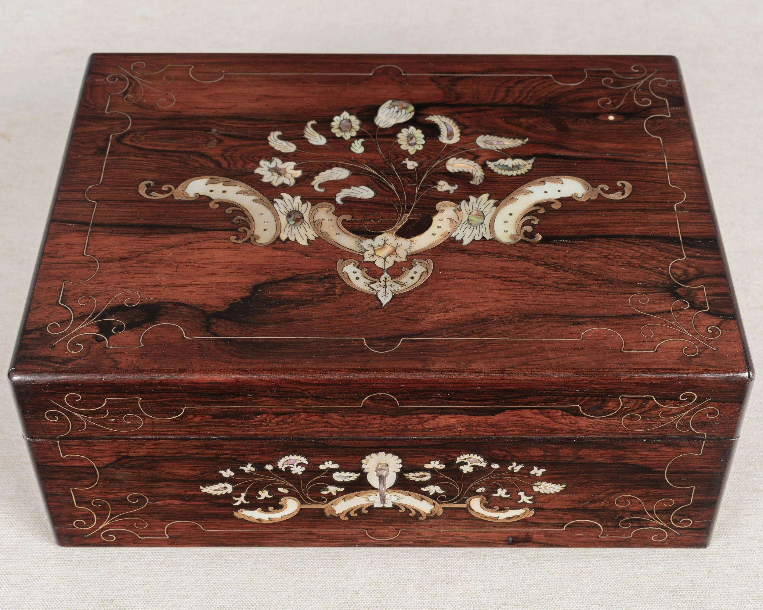 A 19th Century French Napoleon III marquetry box made of rosewood veneer with fine mother-of-pearl and brass inlay.