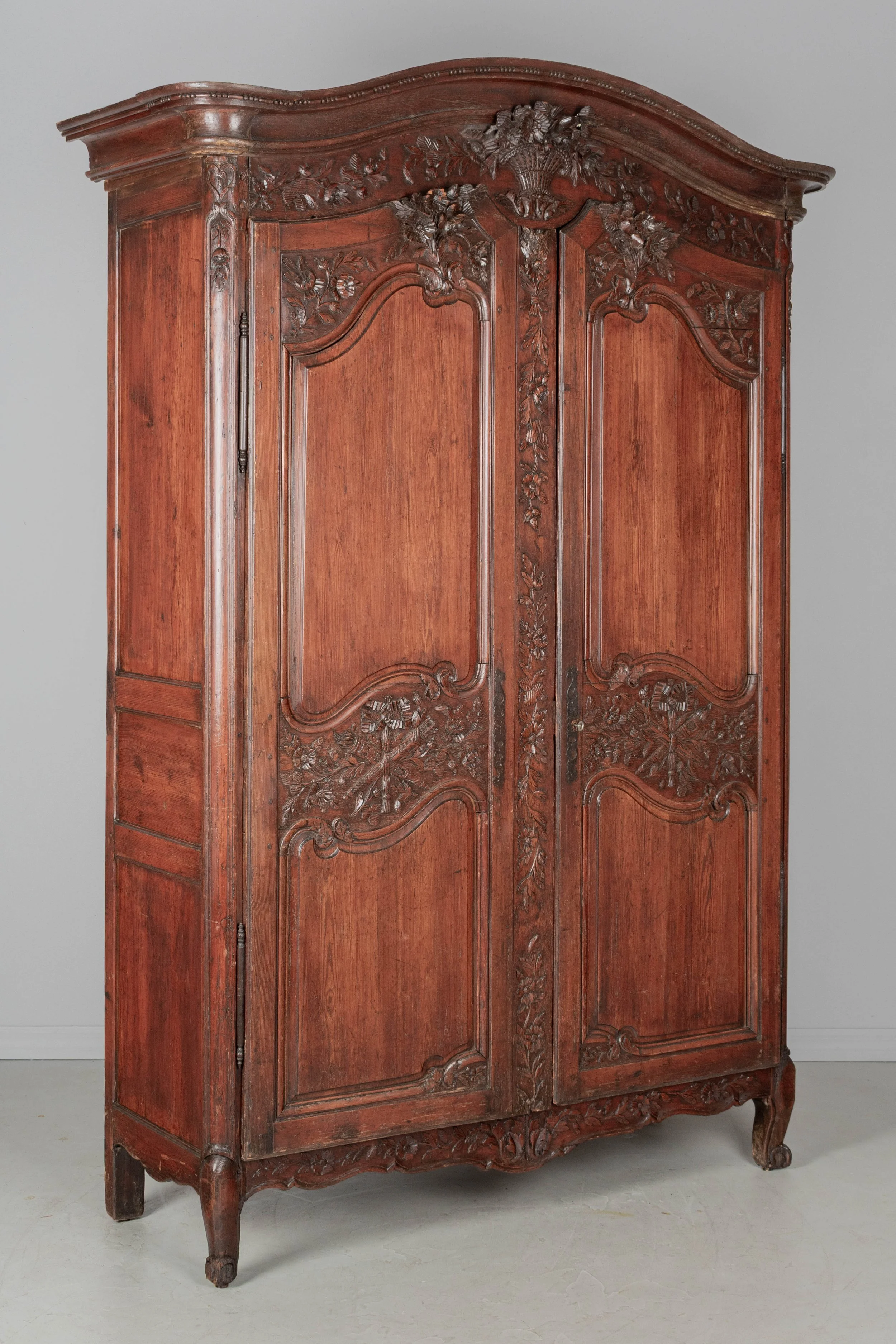 An early 19th century Louis XV country French bridal armoire from Normandy.