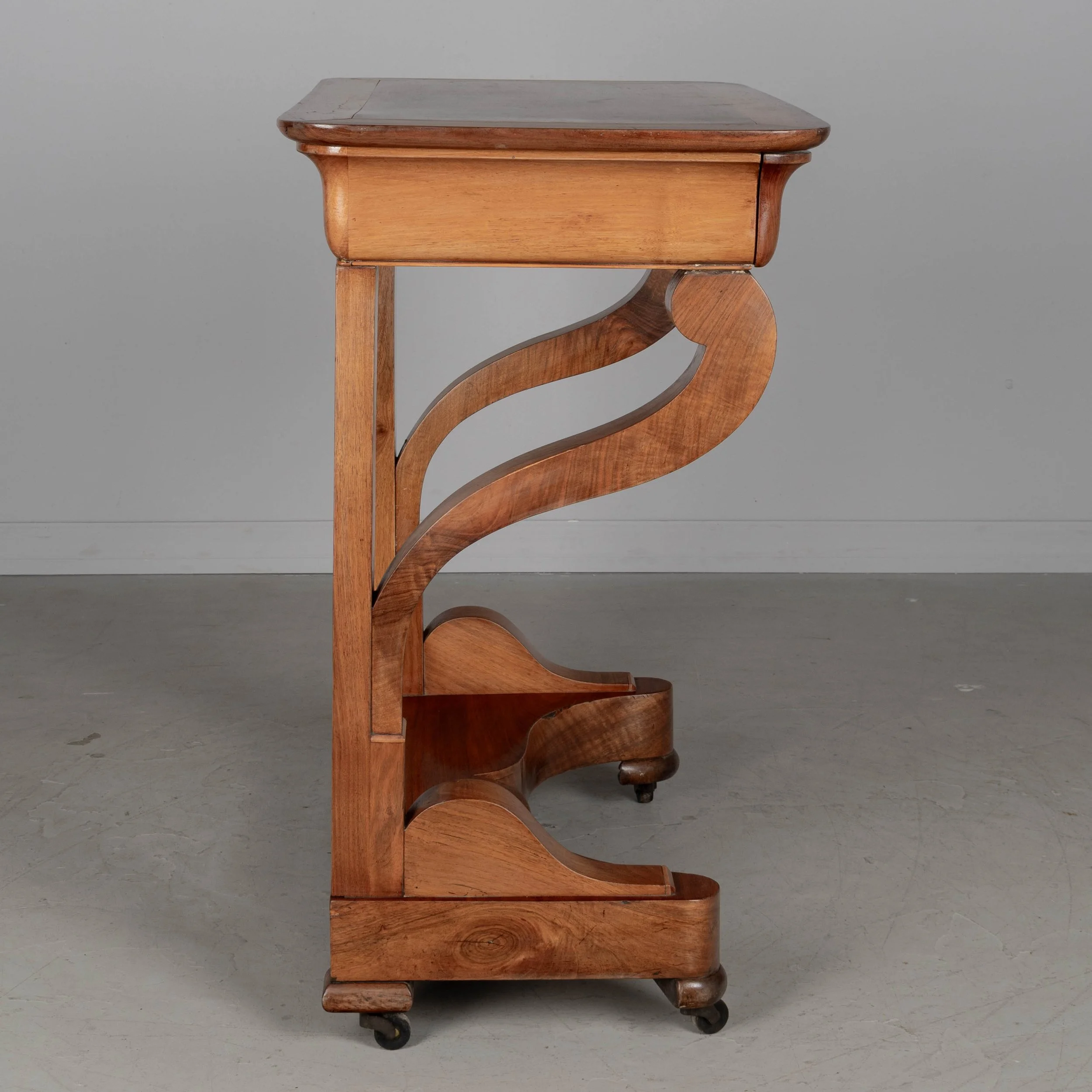 A 19th century French Louis-Philippe console made of solid walnut and veneer of walnut