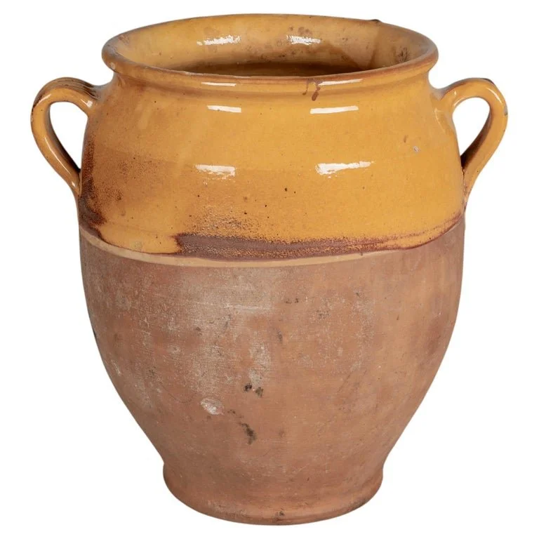 An earthenware confit pot from the Southwest of France with traditional yellow glaze.