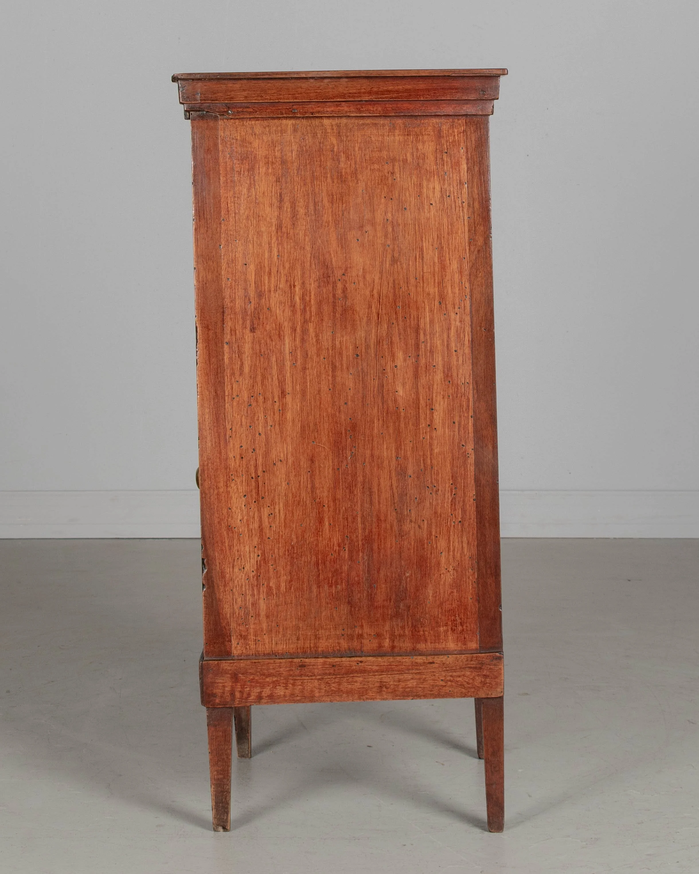 A 19th century French Country walnut side table, or nightstand, with a vertical tambour door above a cabinet door