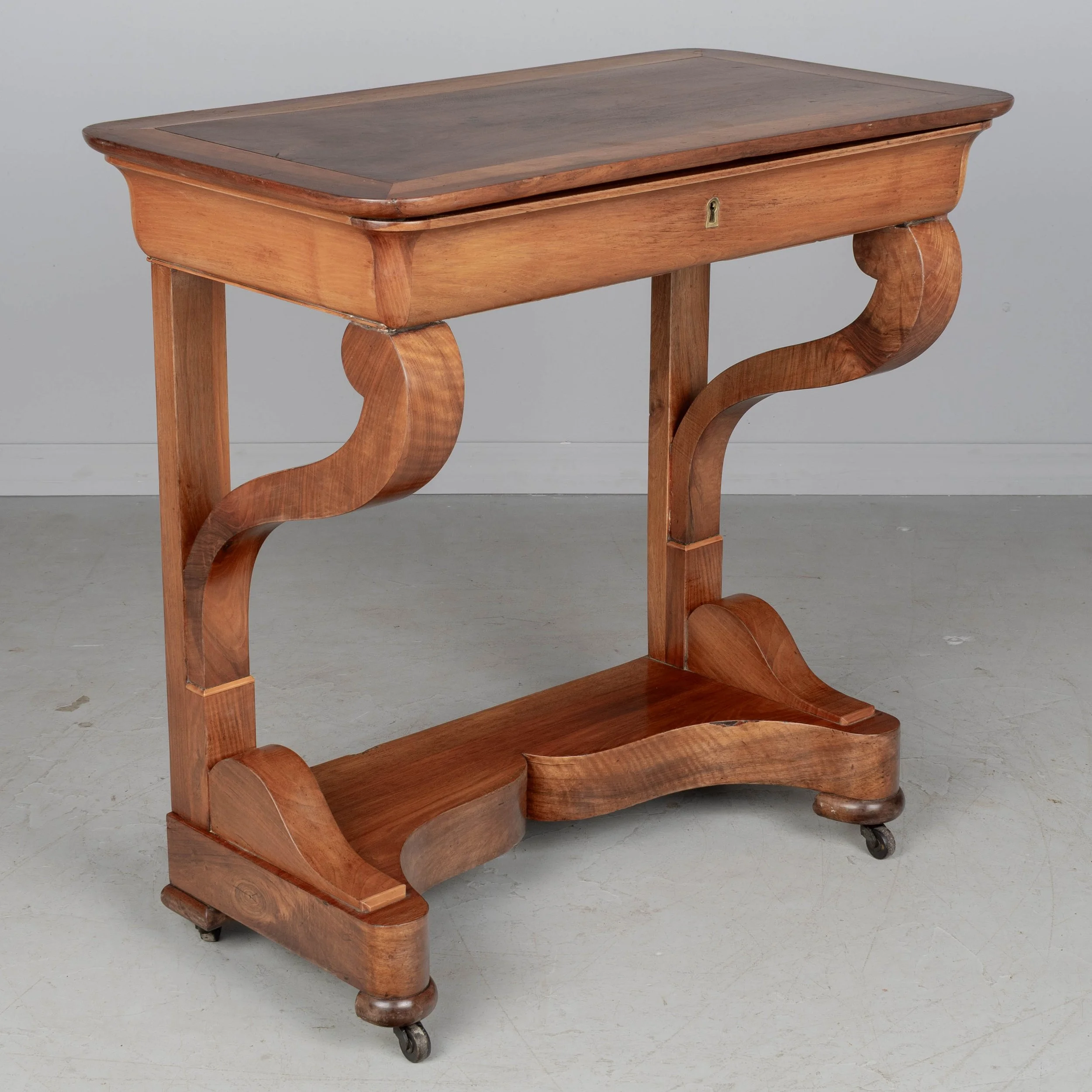 A 19th century French Louis-Philippe console made of solid walnut and veneer of walnut