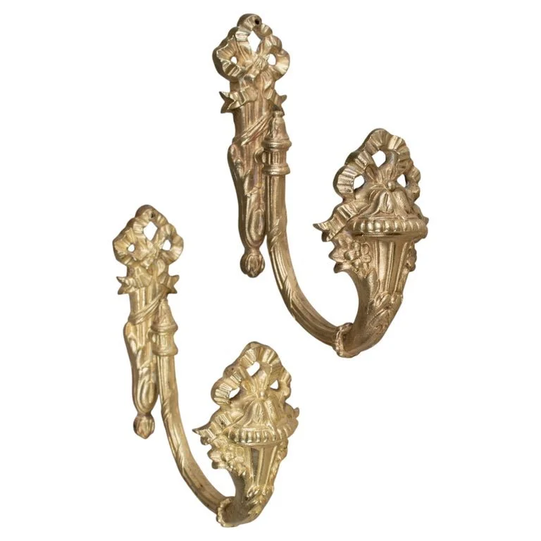 A pair of 19th Century French Louis XVI ctyle cast bronze ormolu curtain tiebacks.