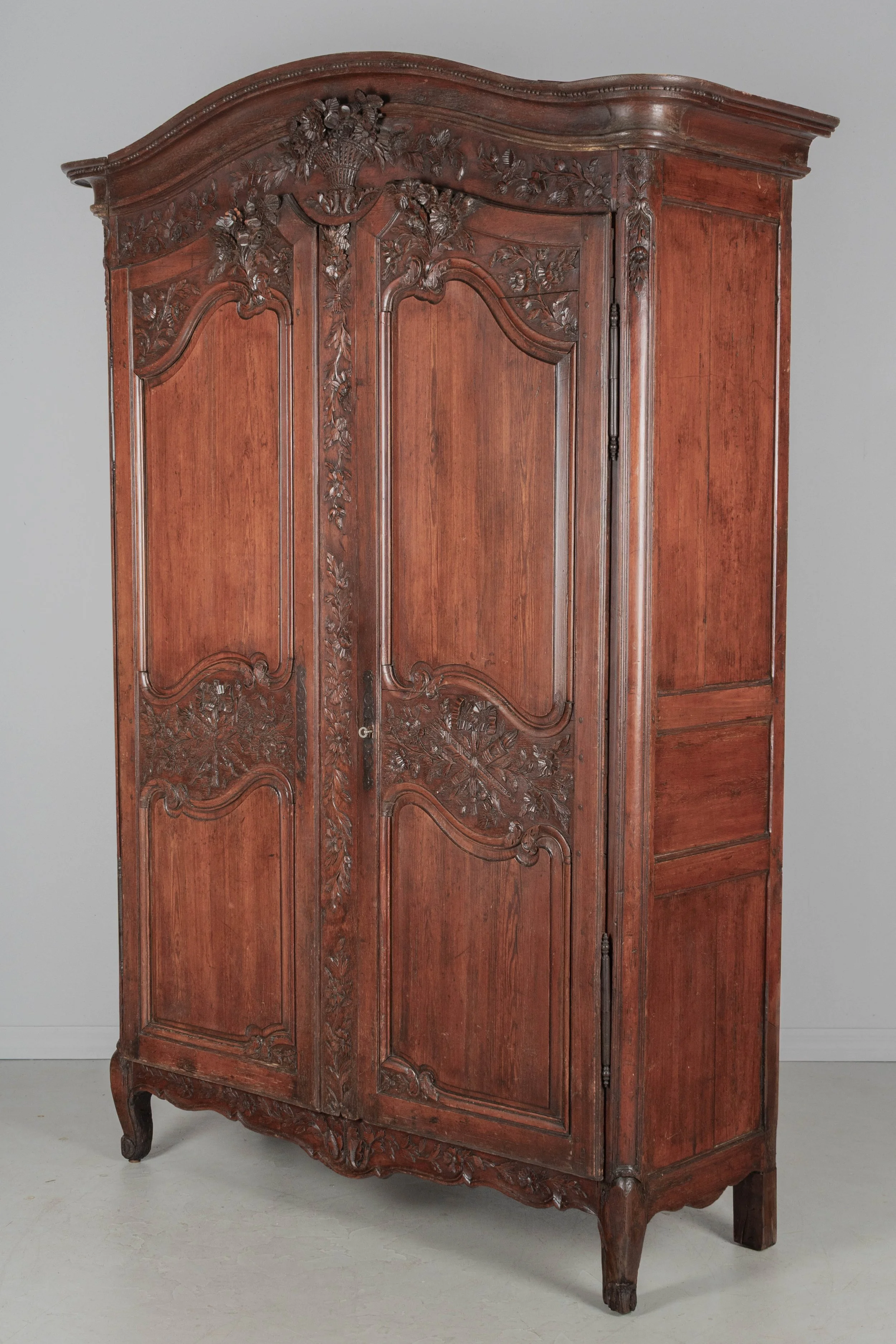 An early 19th century Louis XV country French bridal armoire from Normandy.