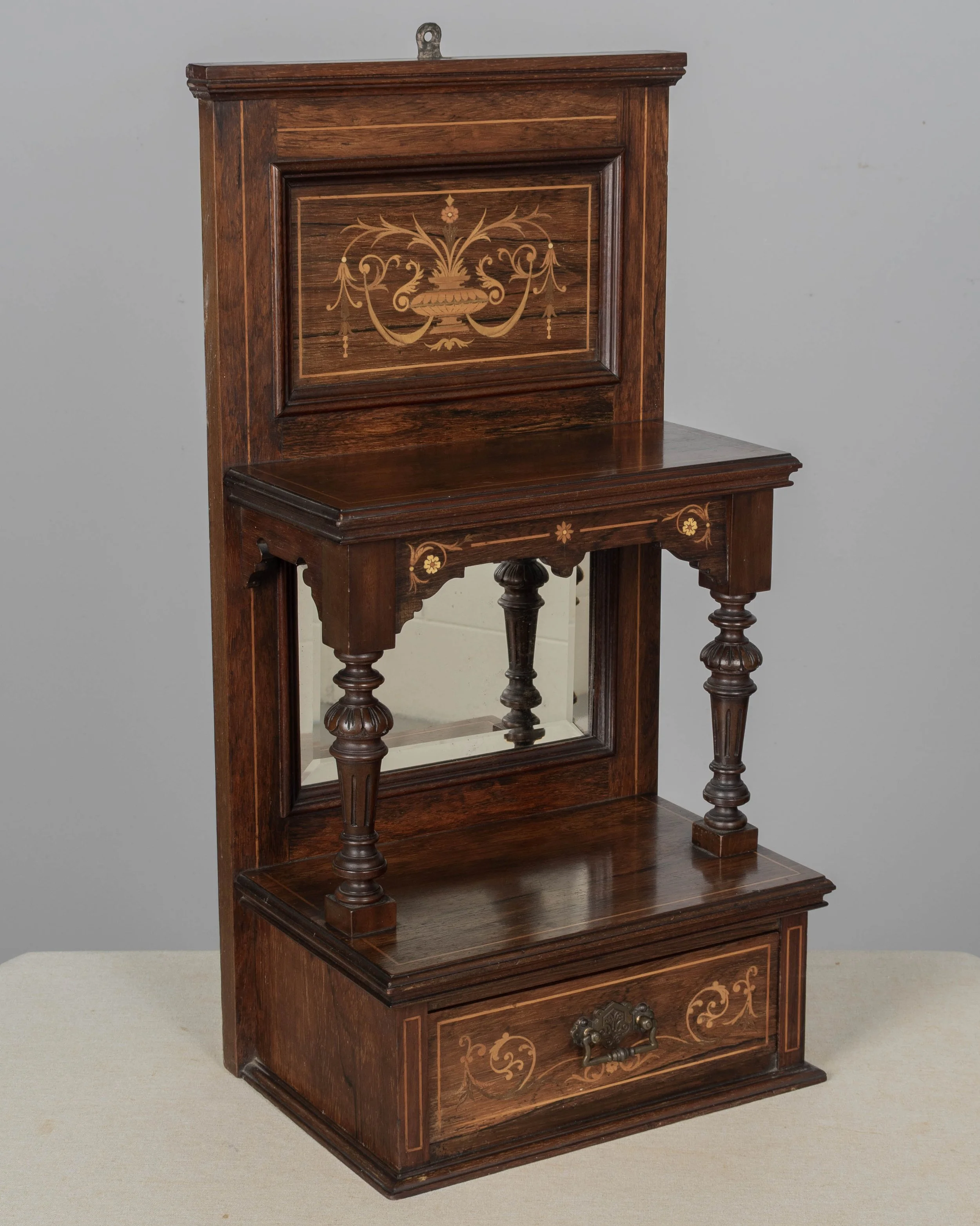 A 19th century English Edwardian vitrine constructed using rich, finely grained rosewood with contrasting satinwood marquetry.