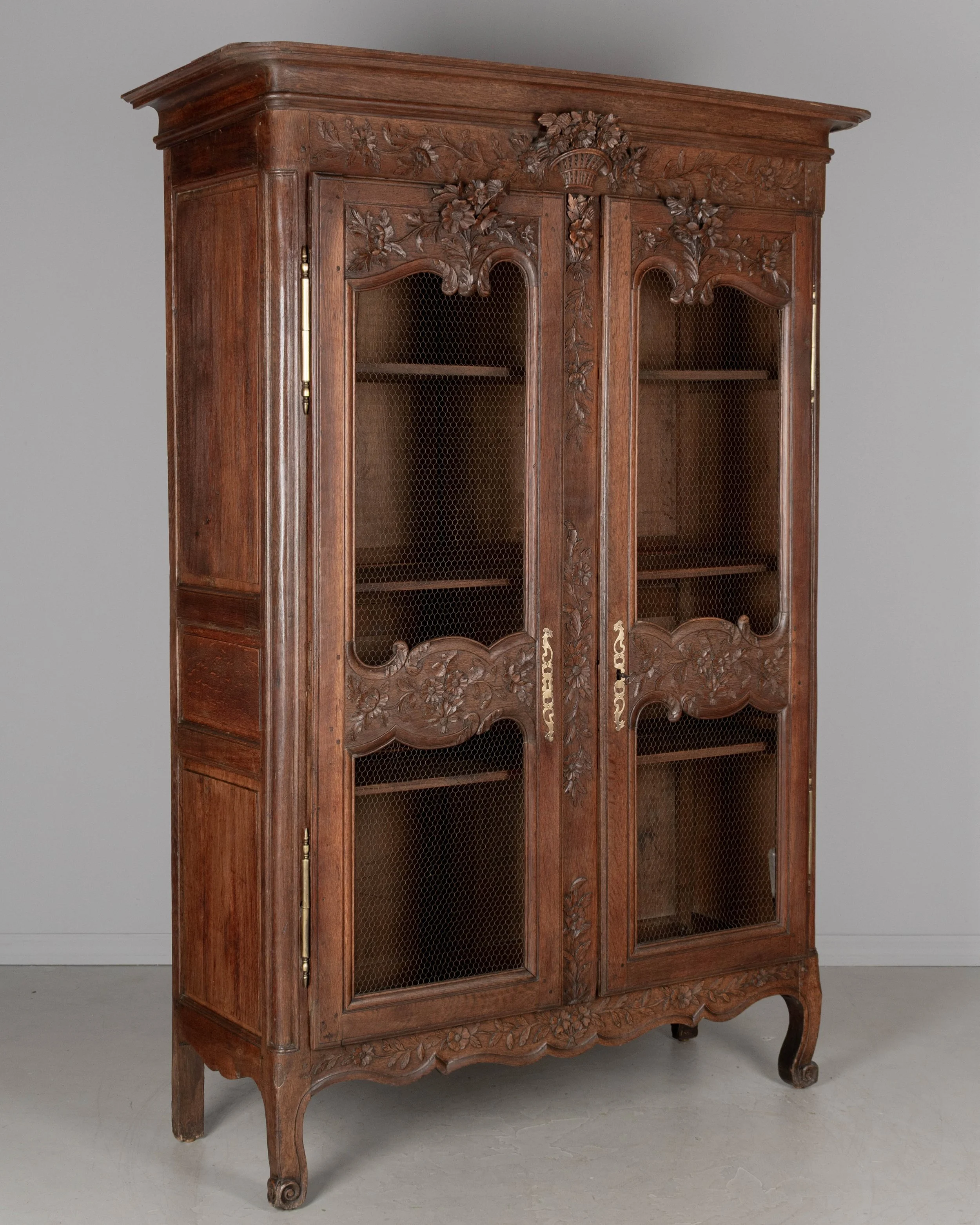 A 19th century Louis XV style Country French armoire, or display cabinet from Normandy.