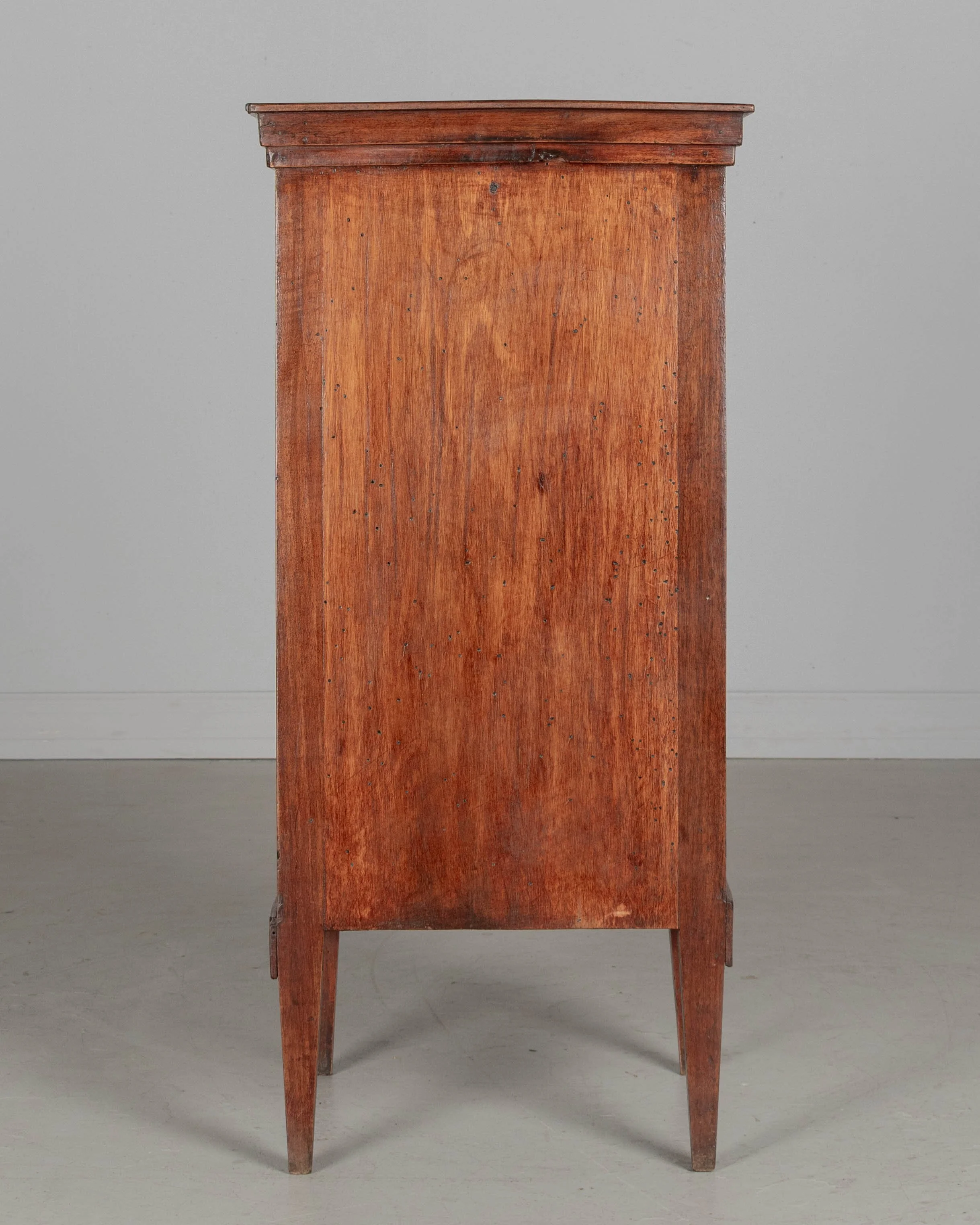A 19th century French Country walnut side table, or nightstand, with a vertical tambour door above a cabinet door