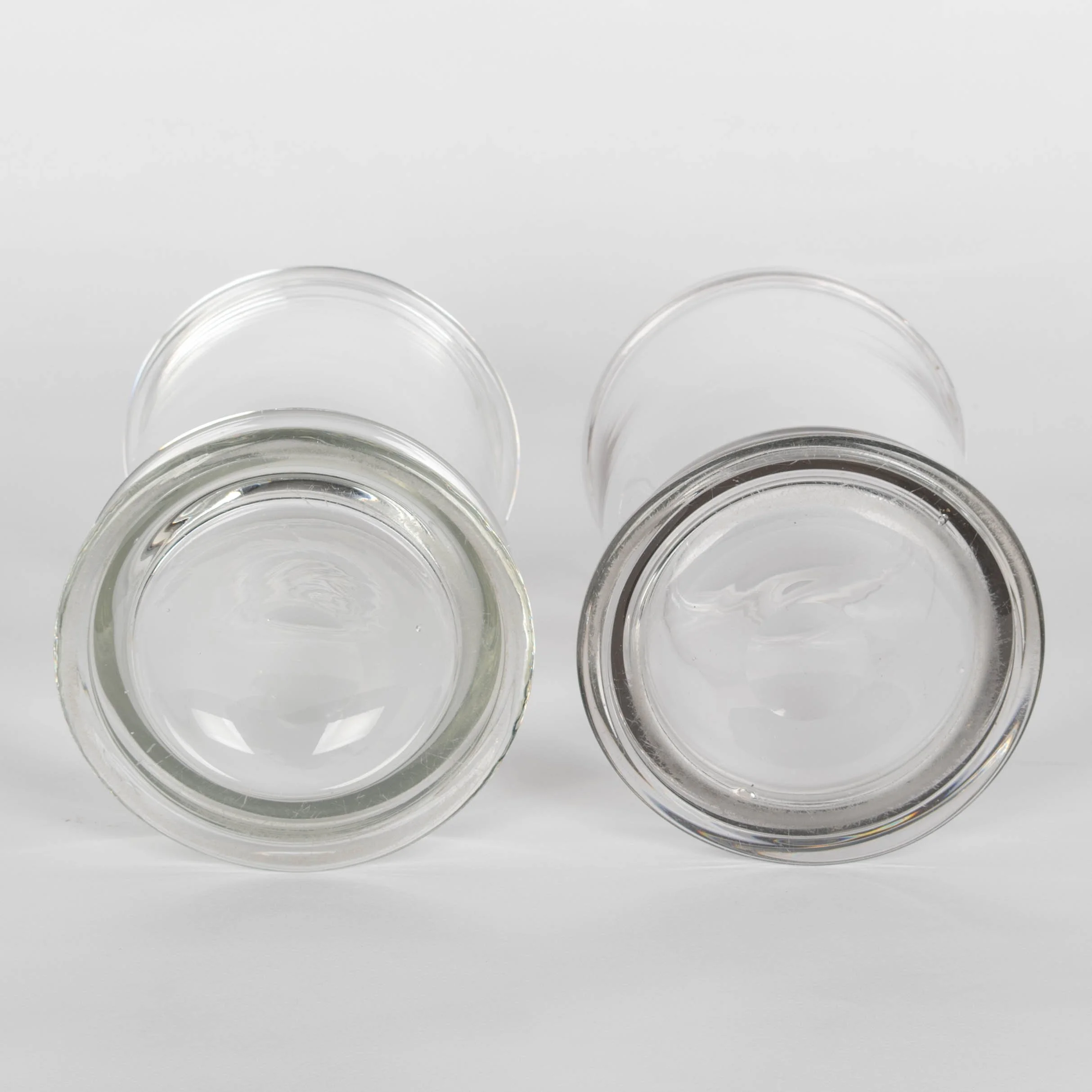 A pair of French hand-blown clear glass lidded apothecary or candy jars