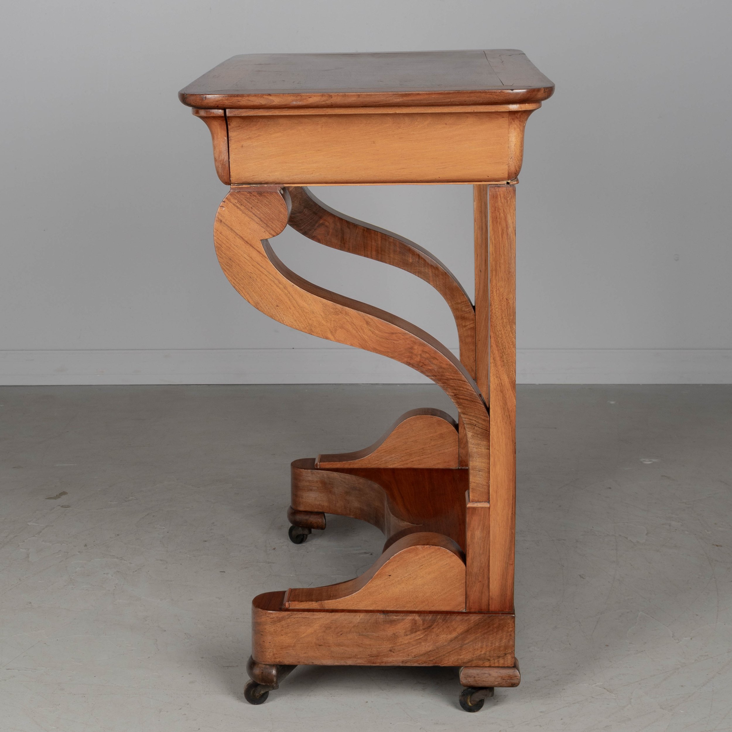 A 19th century French Louis-Philippe console made of solid walnut and veneer of walnut