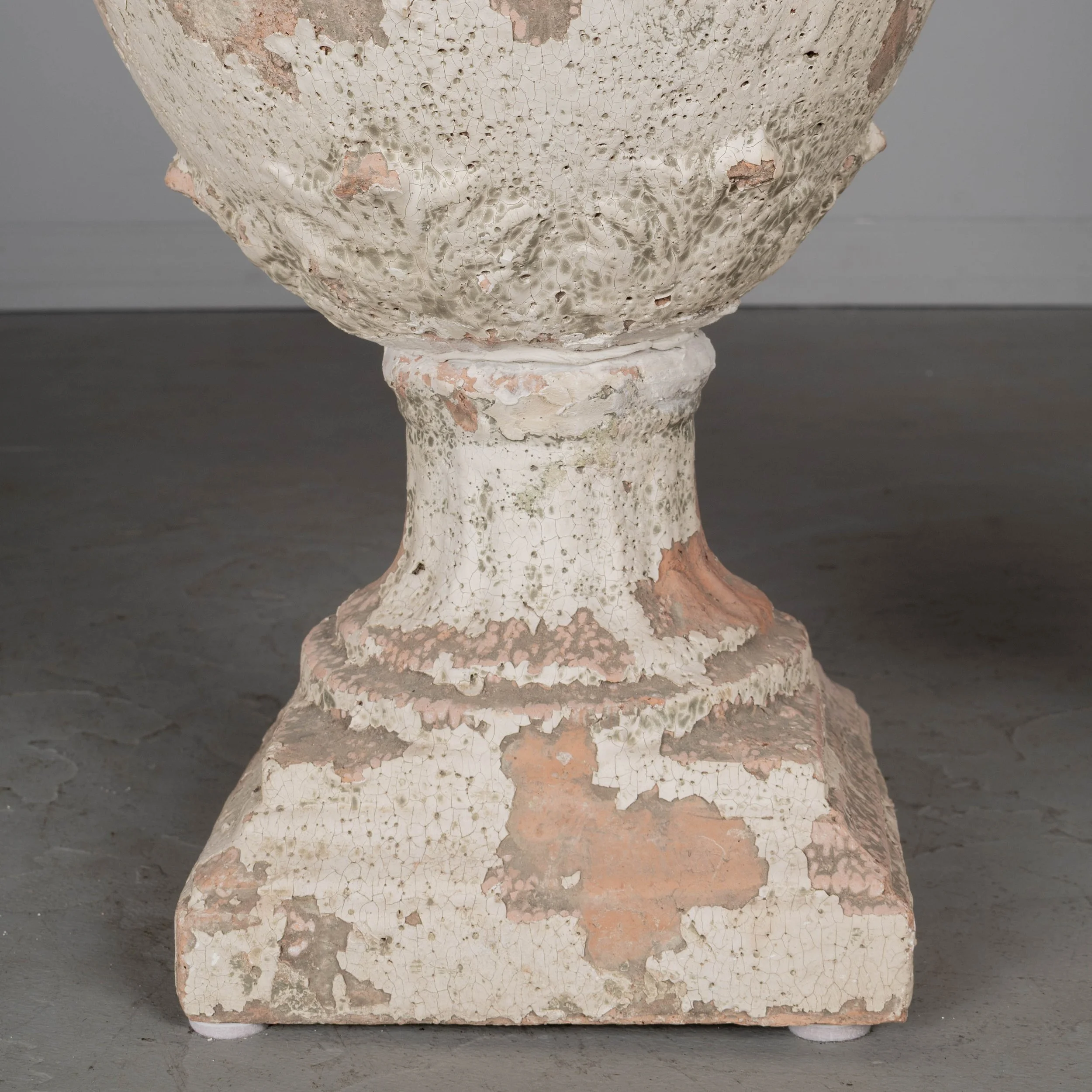 A pair of French terracotta garden urns with lids. Classical vase form on pedestal base, decorated in acanthus leaf motif with large acorn finials on lids.