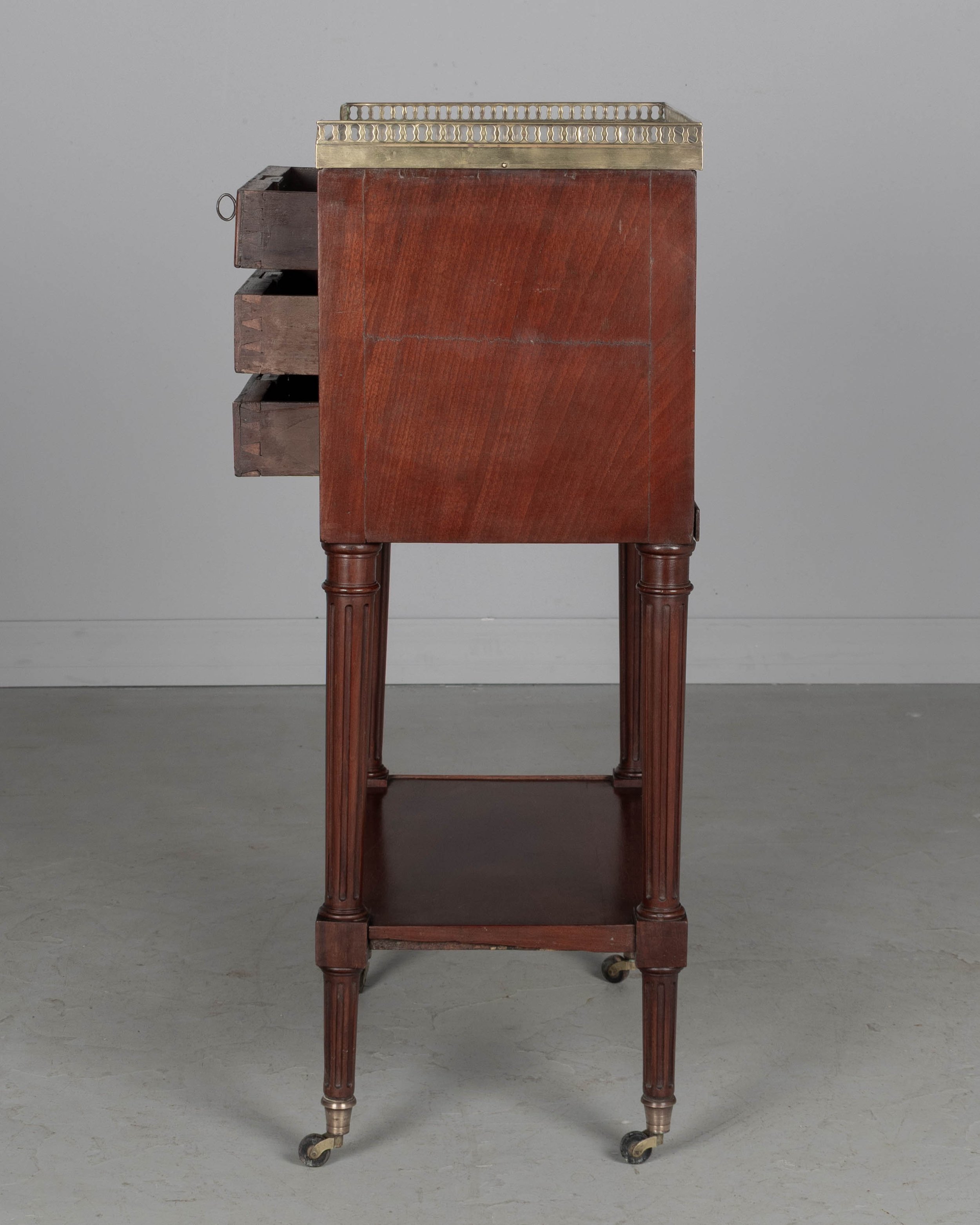 A 19th century French Louis XVI style marble top nightstand, or side table, made of veneers of mahogany with solid oak as a secondary wood
