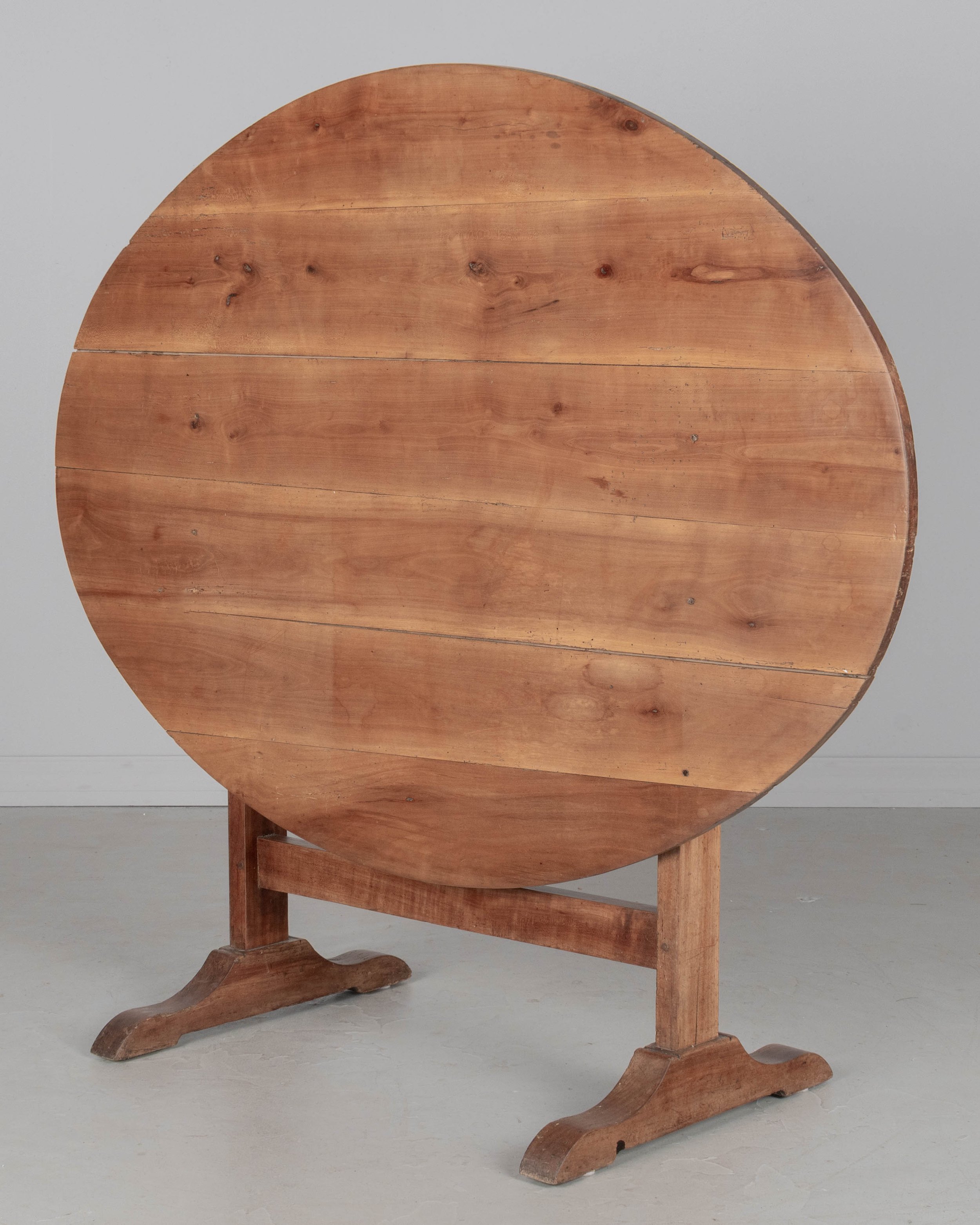 French oval wine tasting, or tilt-top table made of solid cherry.