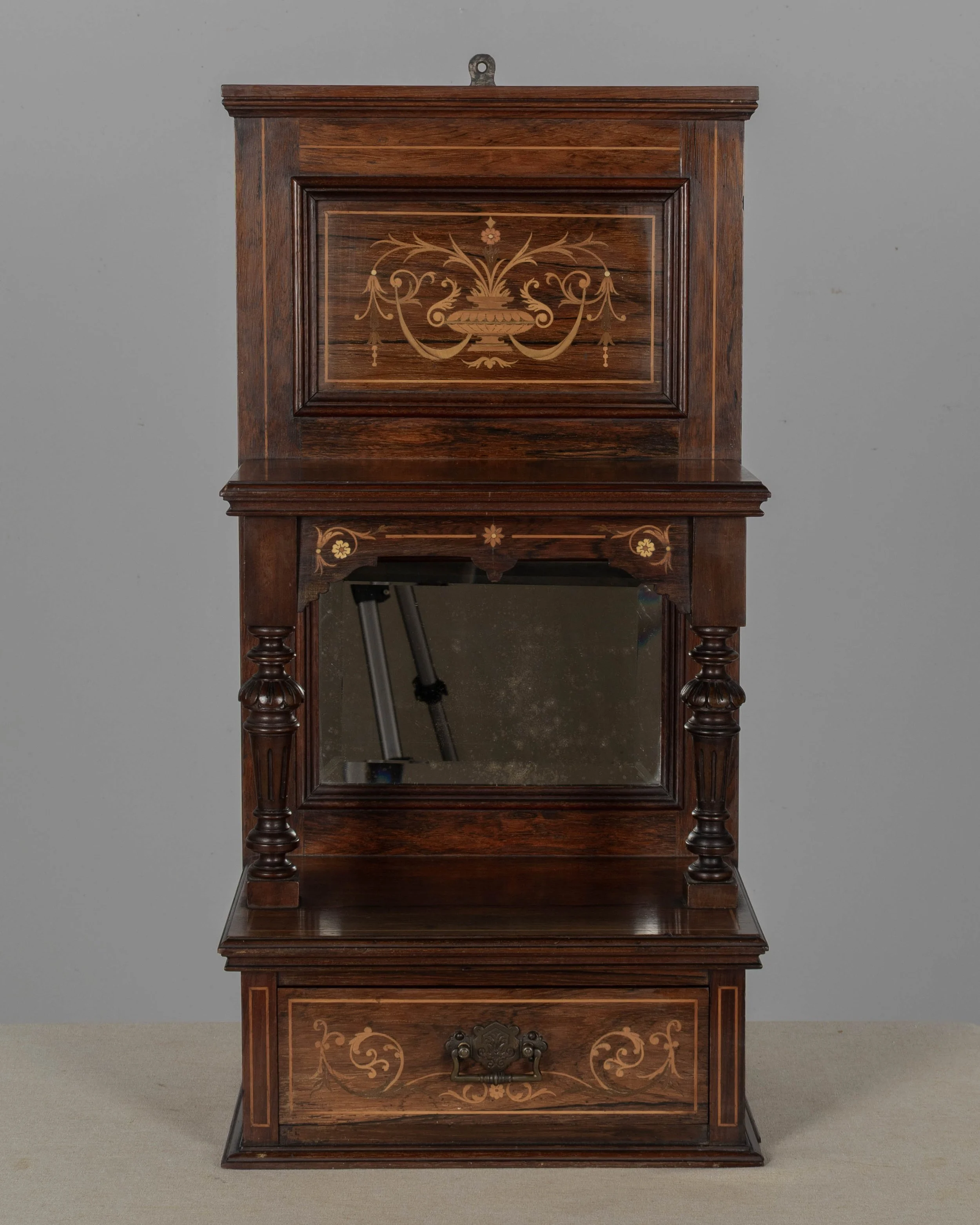 A 19th century English Edwardian vitrine constructed using rich, finely grained rosewood with contrasting satinwood marquetry.