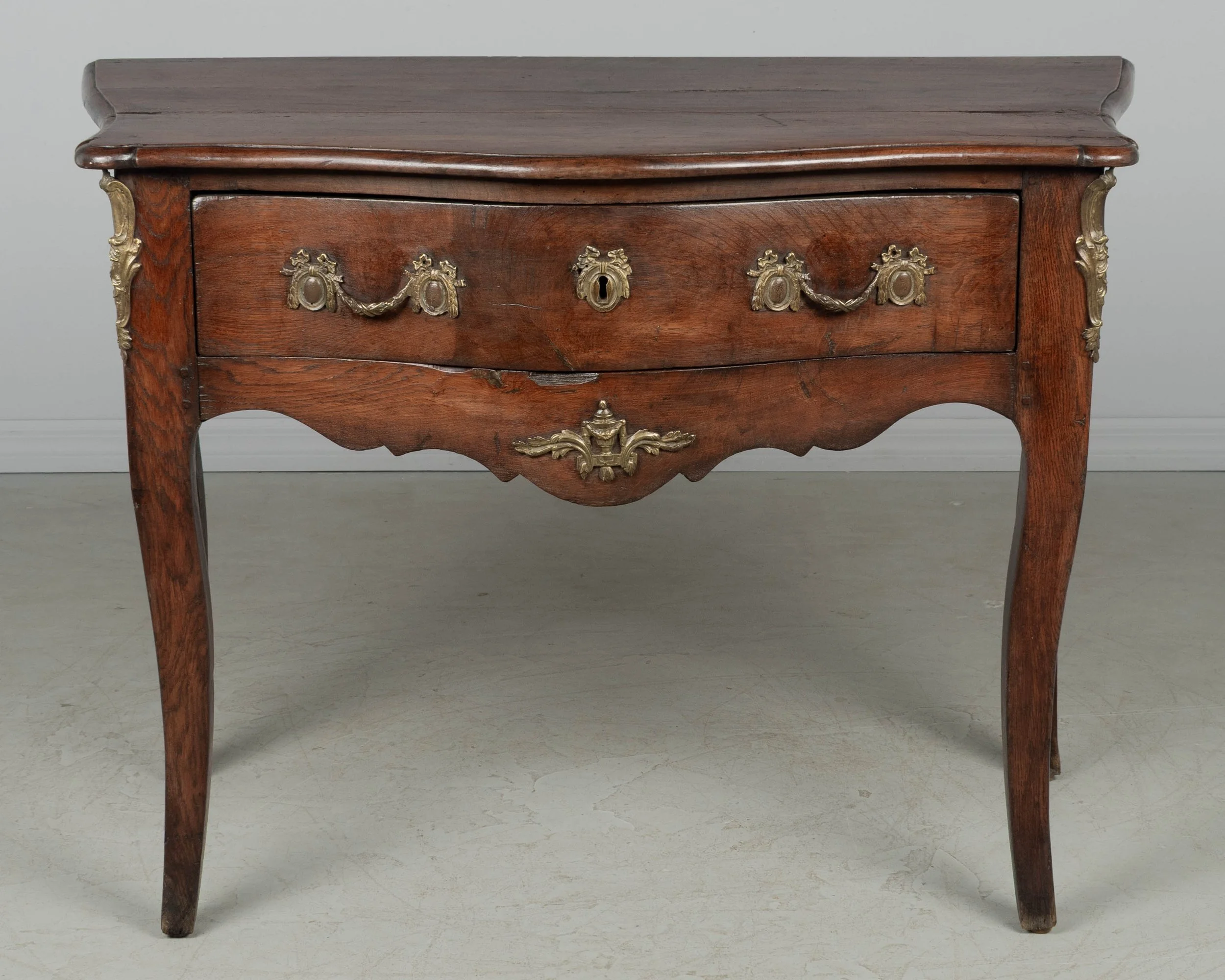 An 18th century Louis XV style French Provençal console table with serpentine front,