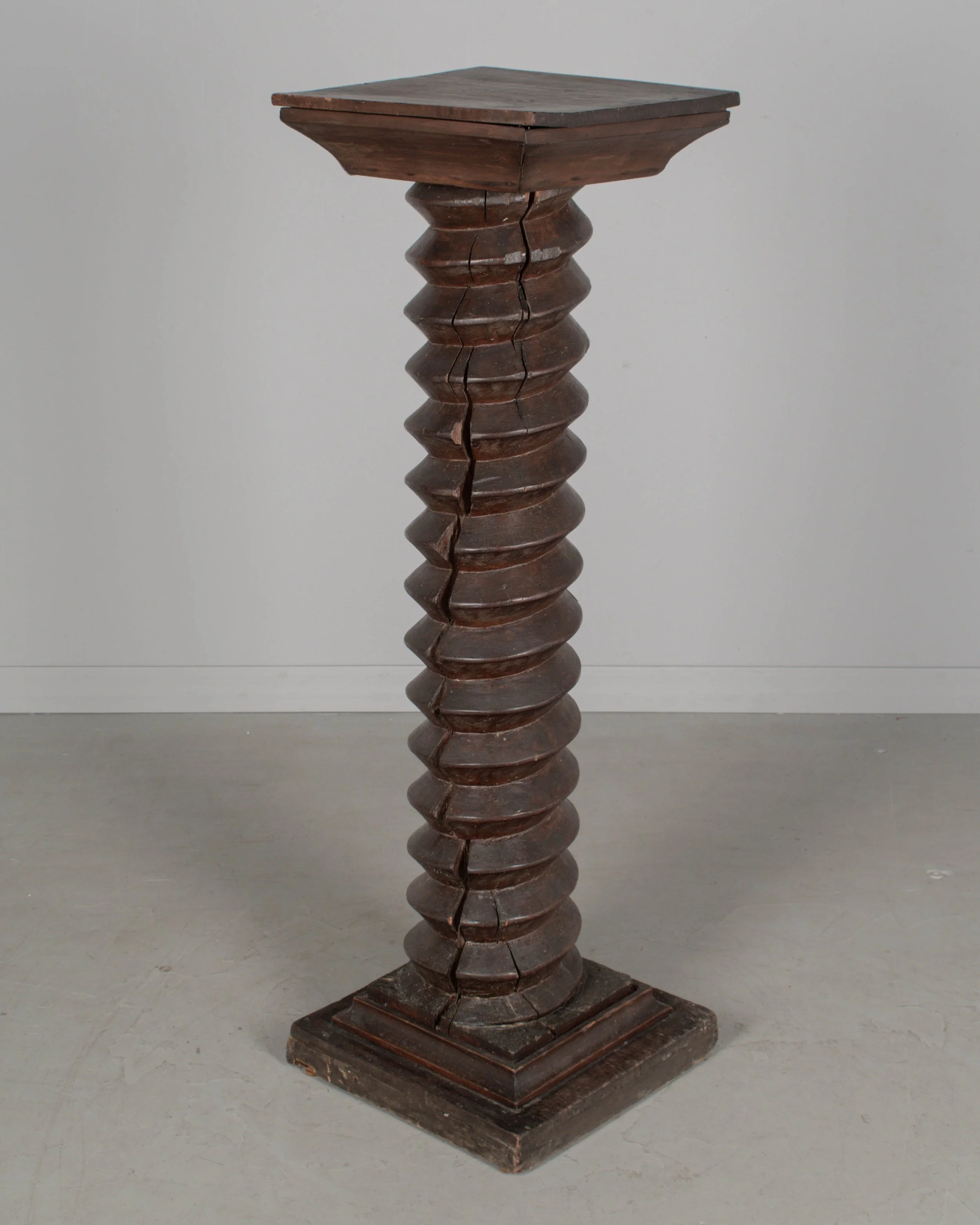 A late 18th century French wooden wine press screw, repurposed as a pedestal or plant stand