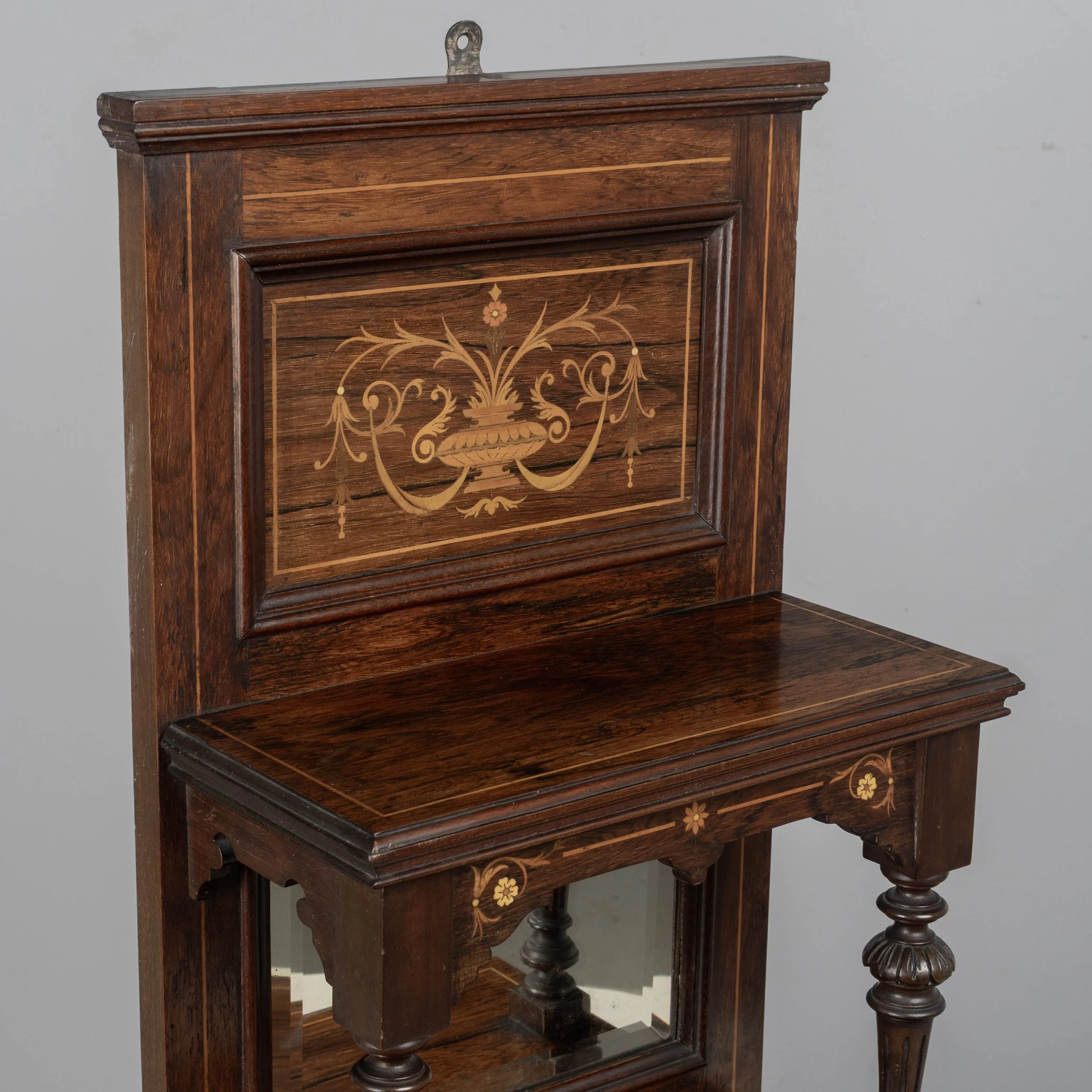 A 19th century English Edwardian vitrine constructed using rich, finely grained rosewood with contrasting satinwood marquetry.