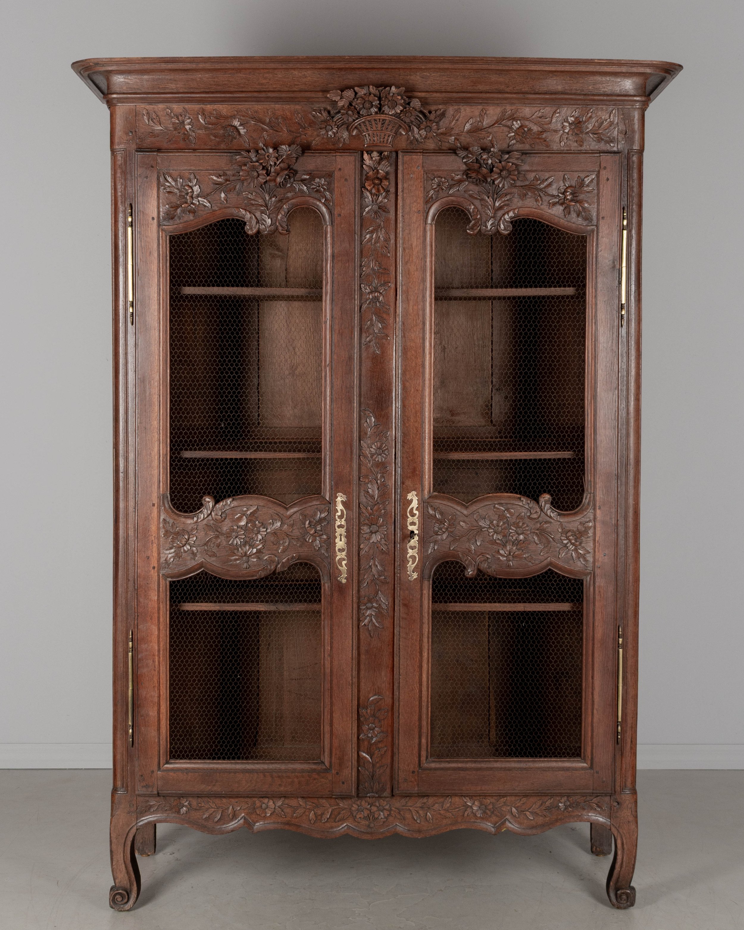 A 19th century Louis XV style Country French armoire, or display cabinet from Normandy.