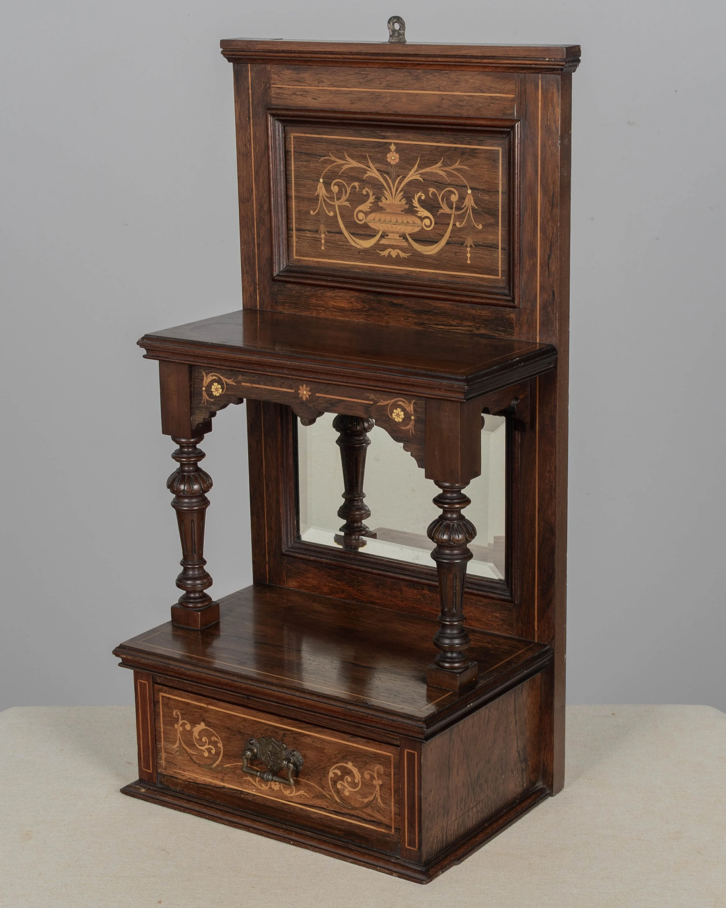A 19th century English Edwardian vitrine constructed using rich, finely grained rosewood with contrasting satinwood marquetry.