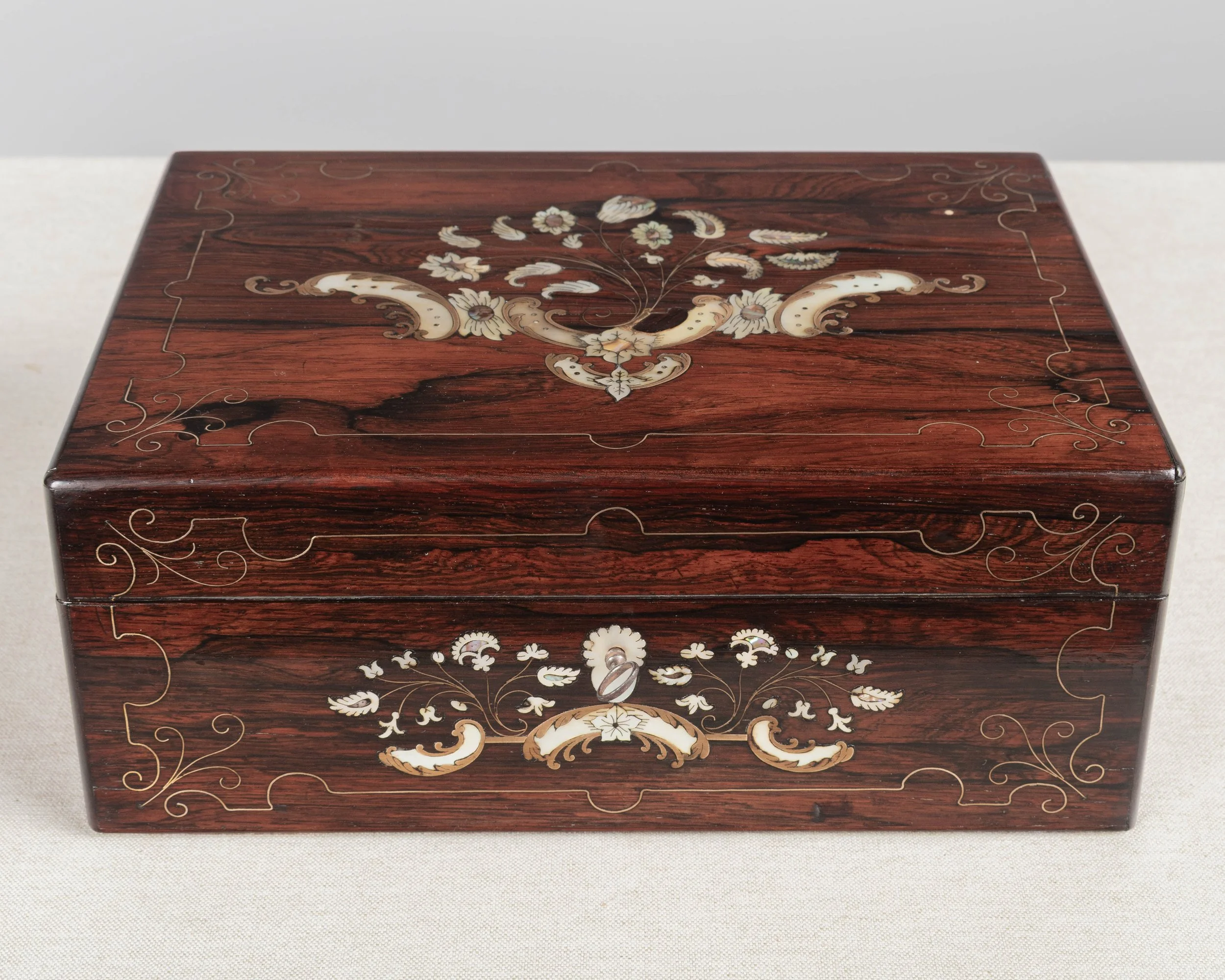 A 19th Century French Napoleon III marquetry box made of rosewood veneer with fine mother-of-pearl and brass inlay.