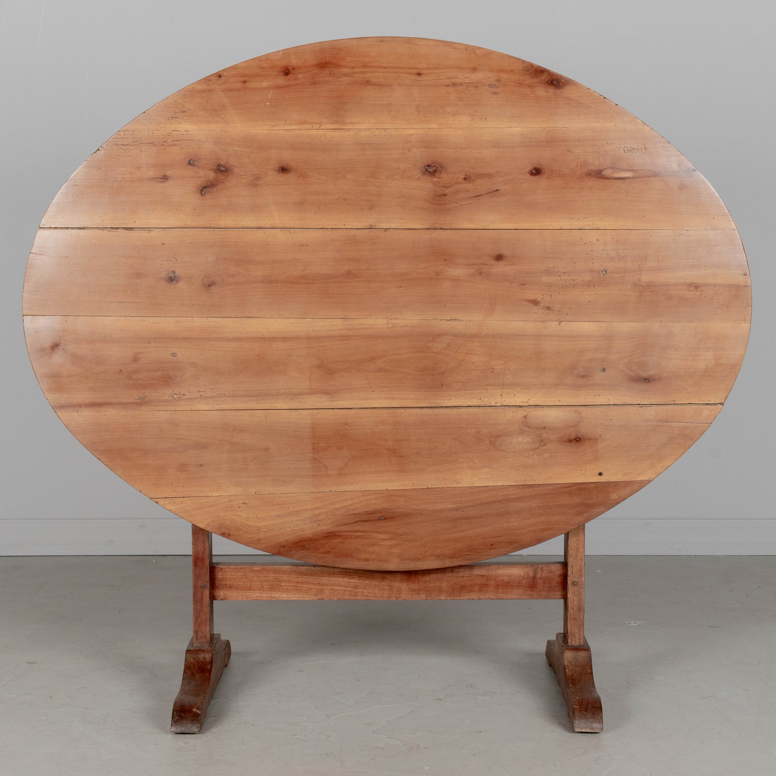 French oval wine tasting, or tilt-top table made of solid cherry.