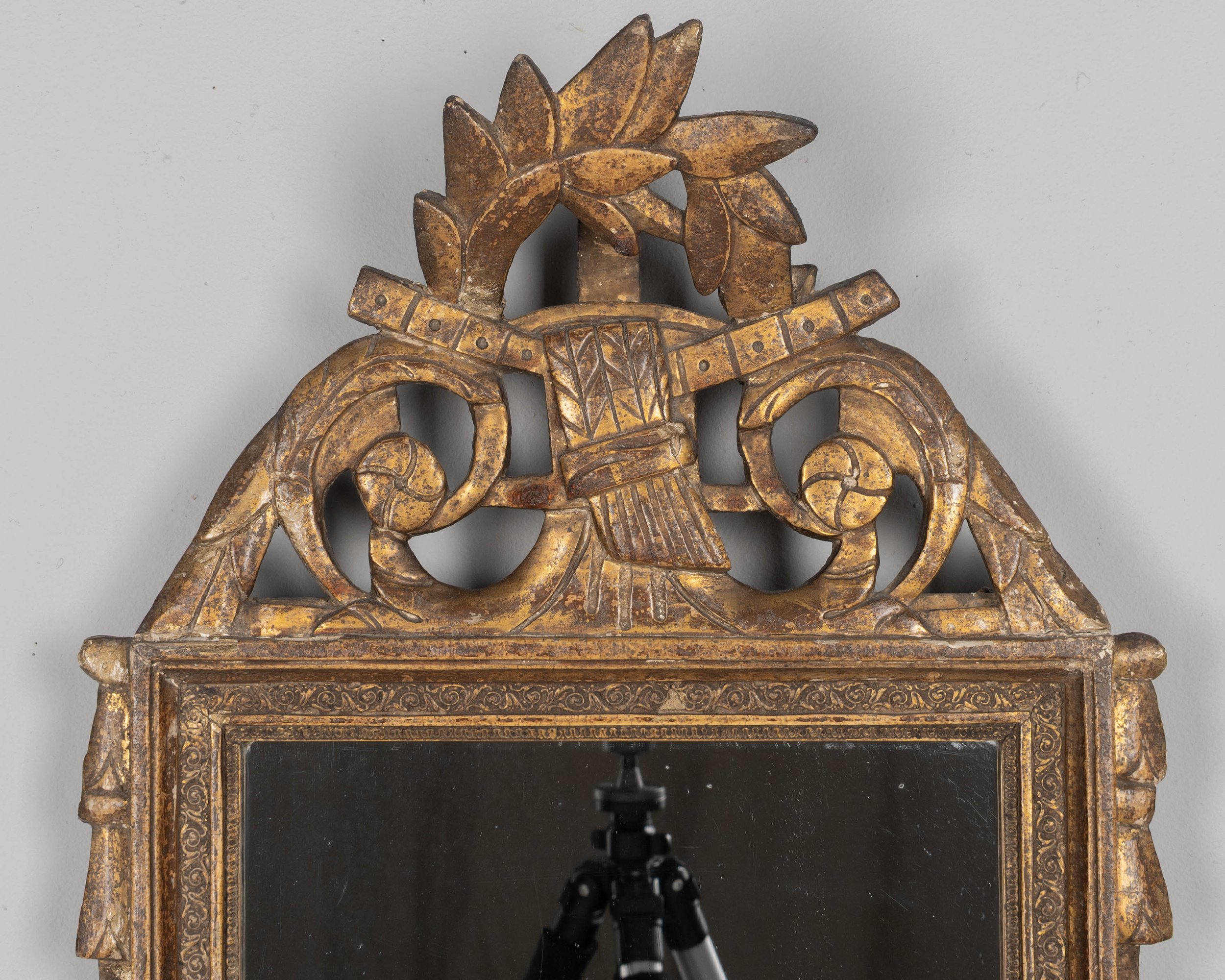 An early 19th century Louis XVI style French Provençal giltwood mirror.