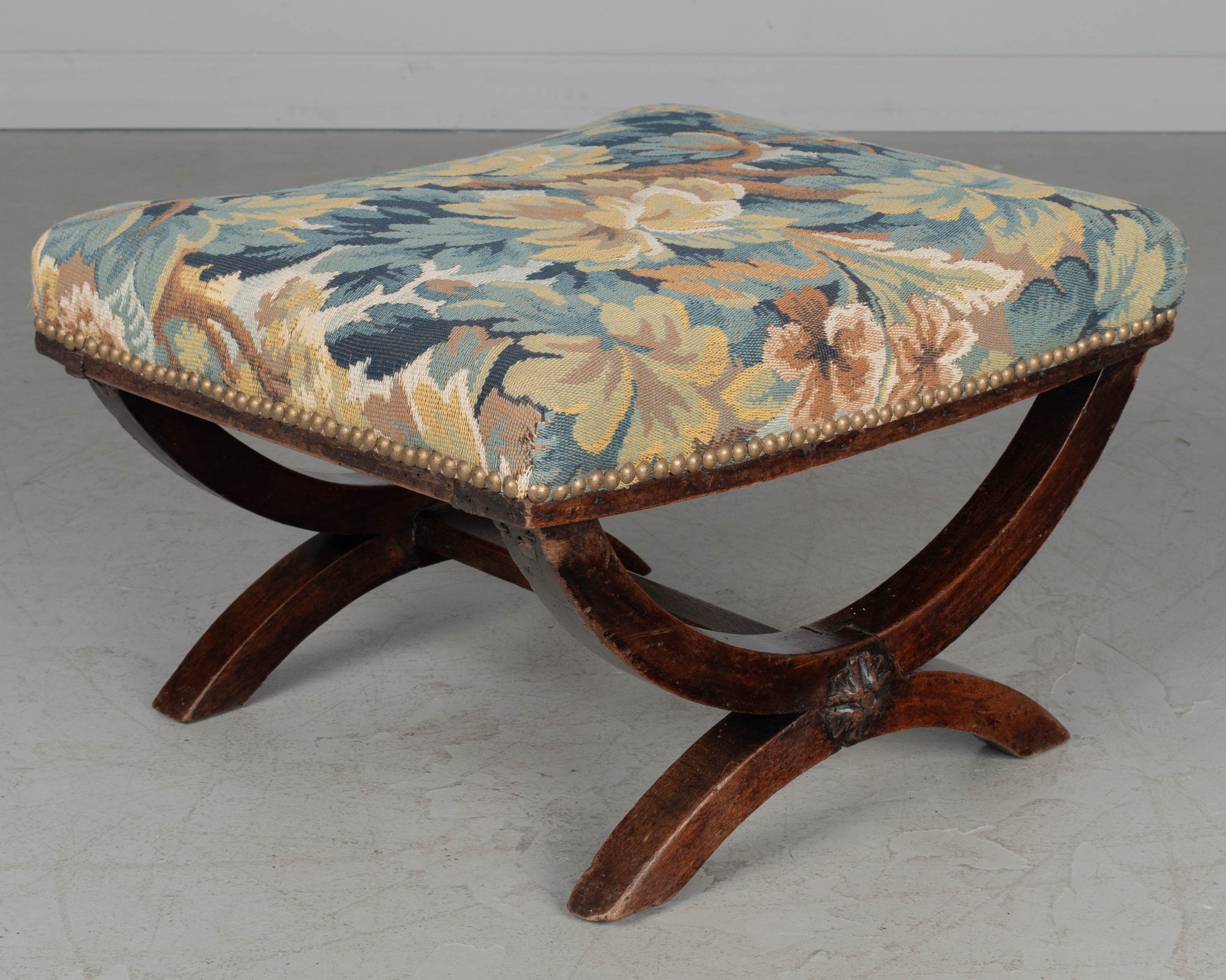 A small 19th century Louis XIII style stool with solid walnut frame and carved medallion detail